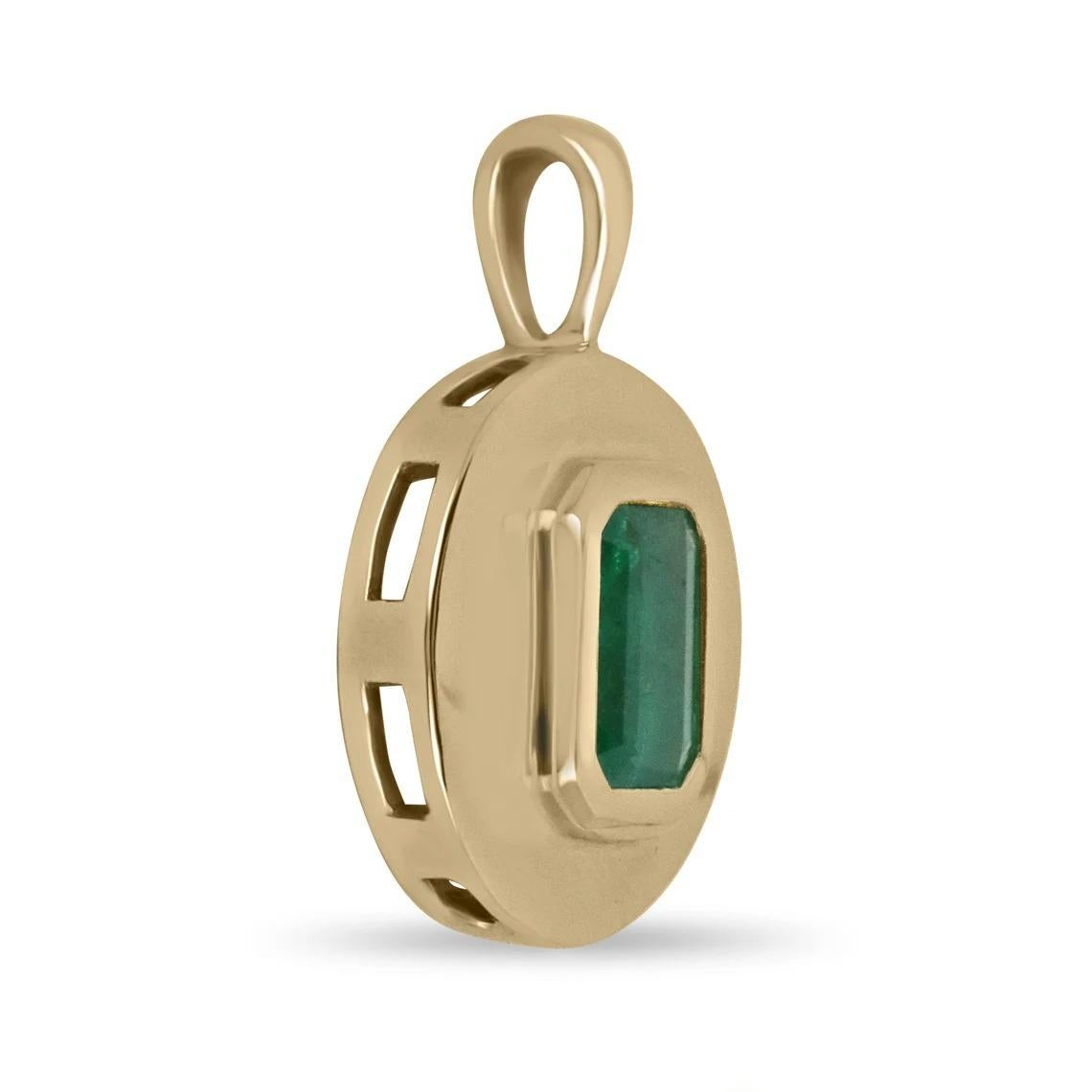 A stunning emerald signet hand-made pendant in solid 14K gleaming gold. This emerald cut-shaped emerald displays a beautiful rare medium rich green color and very good luster. The emerald is bezel set in a custom-made golden frame. A 14K cable chain