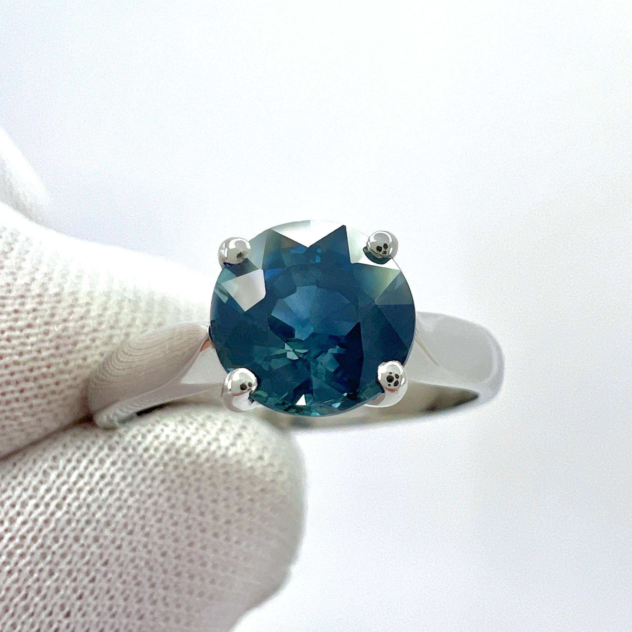 Natural Deep Green Blue Teal Round Cut Sapphire 950 Platinum Solitaire Ring.

1.80 Carat natural sapphire with a unique deep green blue 'teal' colour and excellent clarity. Very clean stone with only some small natural inclusions visible when