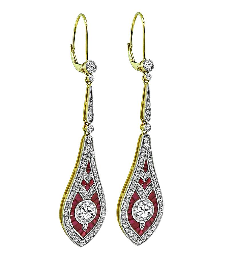 This is a fabulous pair of 14k white and yellow gold drop earrings. The earrings feature 2 large sparkling round cut diamonds that weigh approximately 1.00ct. The color of the diamonds is G-H with VS2 clarity. The large diamonds are accentuated by