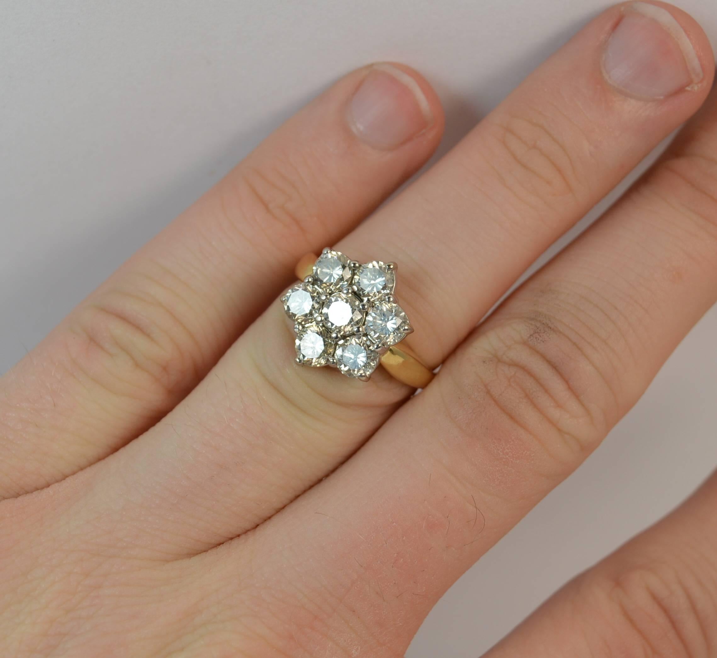 
A stylish 18 carat yellow gold and diamond ring.

​The daisy cluster is comprising of seven round brilliant cut diamonds to total 1.80 carats approx. 12mm x 13.5mm head.

​18 carat yellow gold shank with a white gold head setting.

​Bright, clean