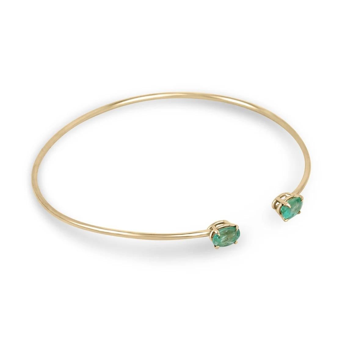 The toi et moi cuff bangle bracelet is a stunning piece of jewelry that symbolizes the intertwining of two individuals. This exquisite bracelet features two oval cut emeralds, weighing a total of 1.80 carats, set in a four claw prong setting. The