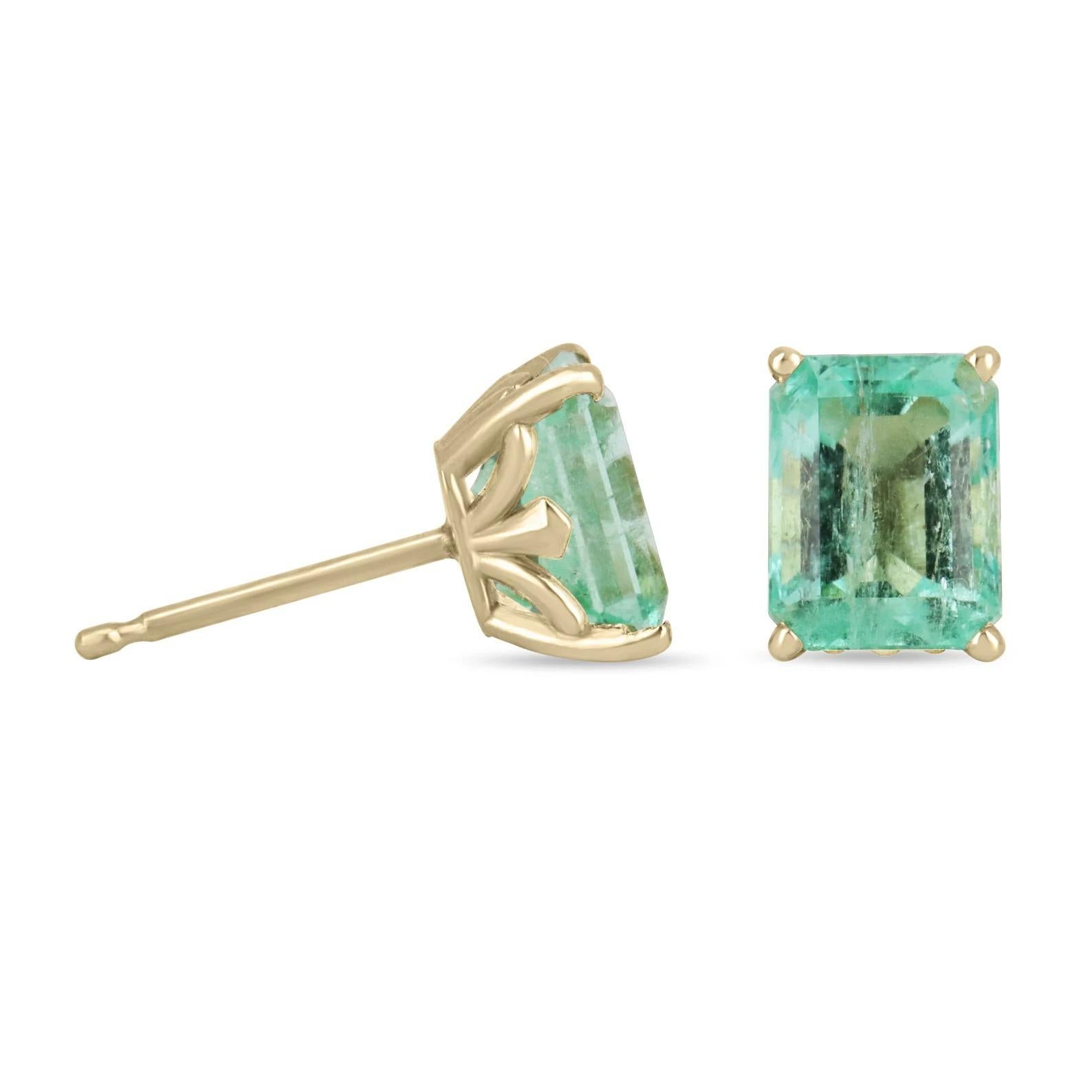 A classic pair of emerald-cut green natural Colombian emerald gold studs in 14K Gold. These earrings feature two lively, natural Colombian emeralds that are handset in a single four-prong setting. These stones were sourced by the best emerald mine
