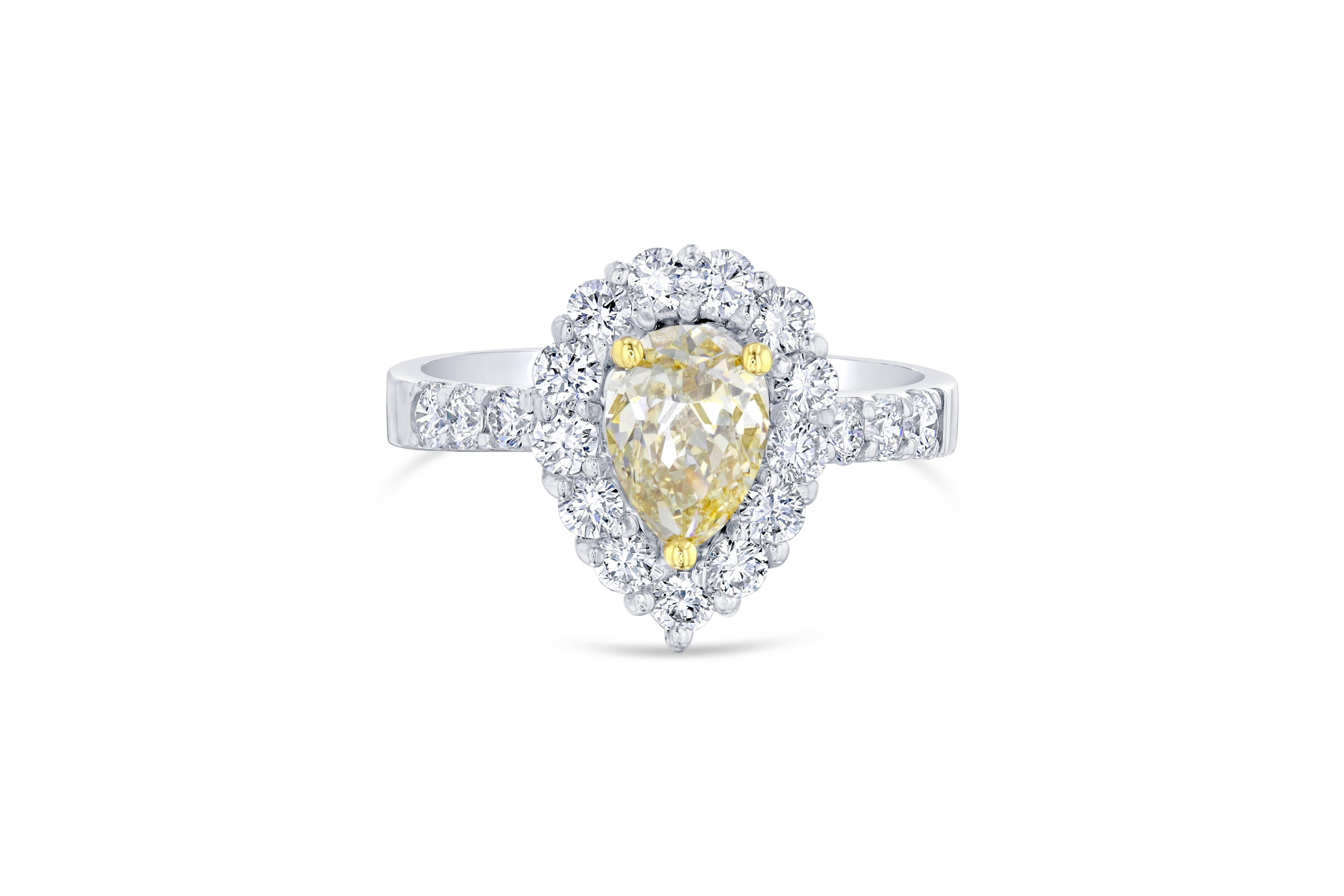 A gorgeous engagement ring that will leave her breathless! 

The center fancy colored diamond is a pear cut weighing 1.06 carats. The center diamond has a clarity of VS2 and the color is brownish-yellow. It is surrounded by 19 round cut diamonds