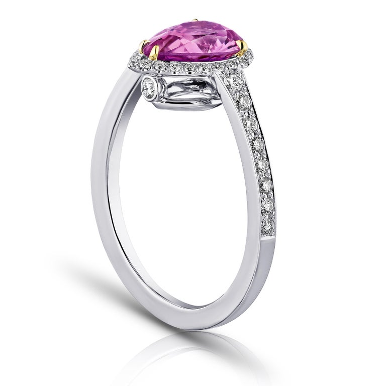 1.81 carat pear shape pink sapphire with 42 round diamonds .34 carats set in a platinum ring. Size 7.
