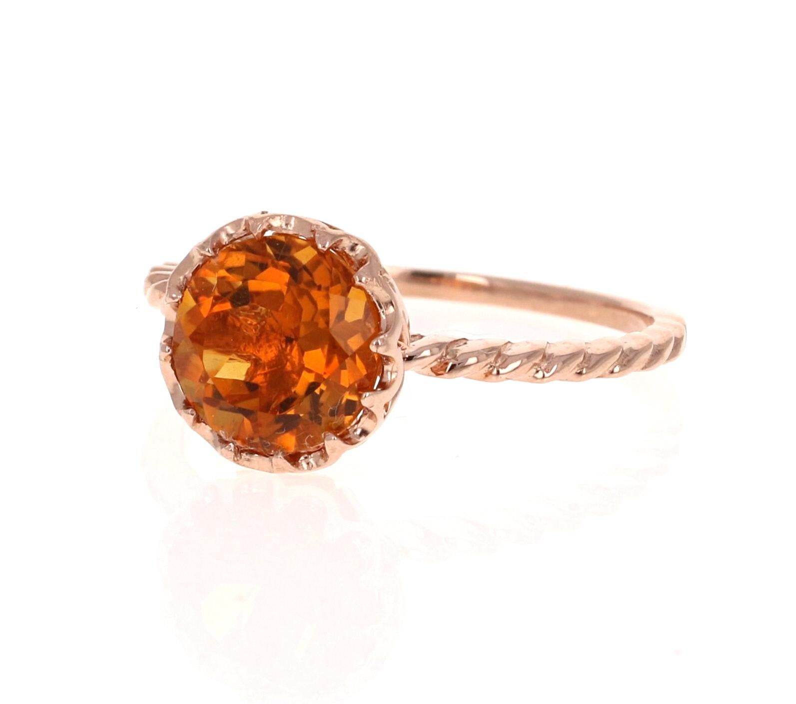 This beautiful and simple ring has a bright and vivid Round Cut Citrine Quartz in the center that weighs 1.81 carats. 
It is set in a beautifully crafted wire style 14 Karat Rose Gold setting and weighs approximately 1.8 grams.  Very light weight