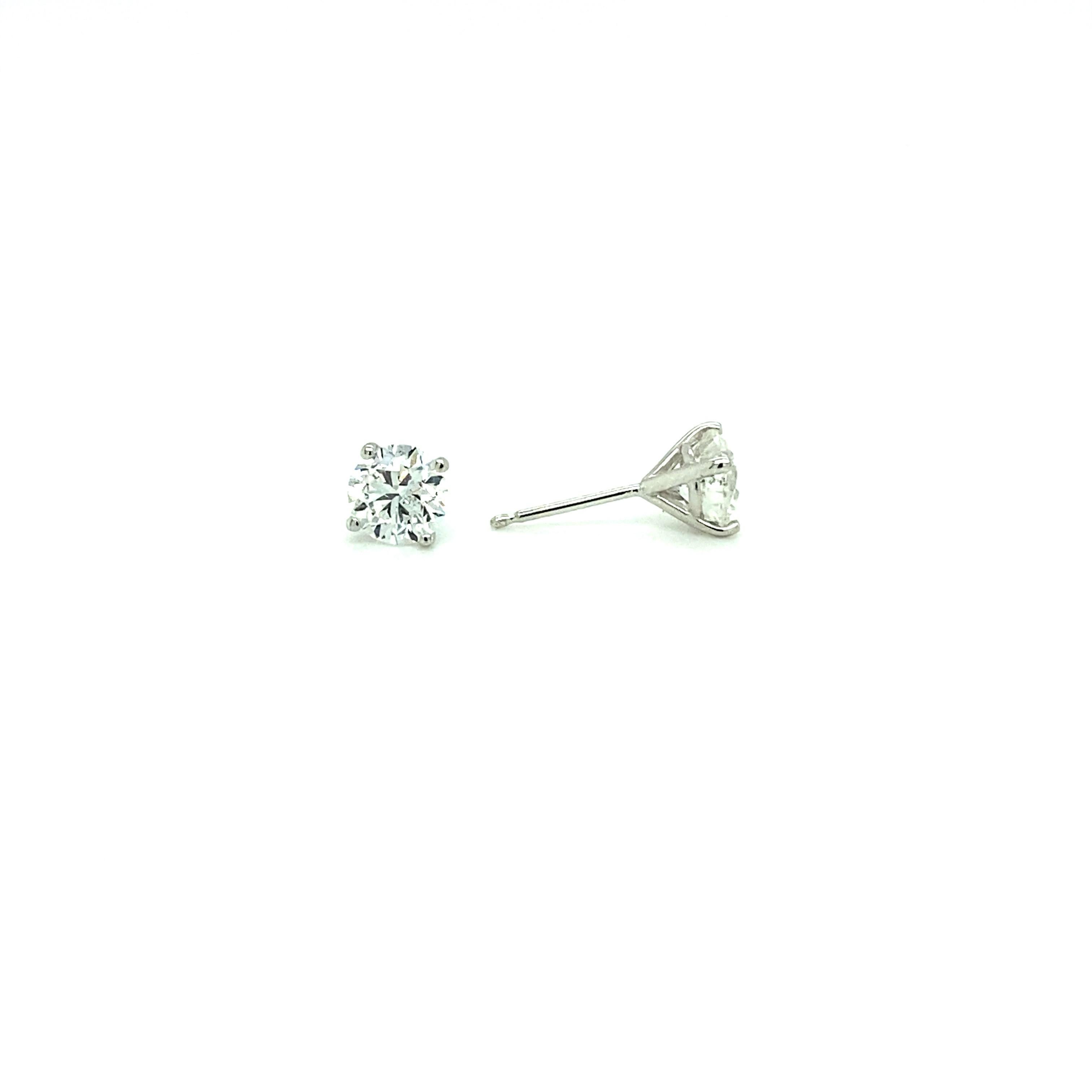 Offered here is a classic 1.81 ct total weight Diamond stud. 
Diamonds are set in a 4-prong martini setting with heavy push-backs. 
The earrings are 14kt White Gold. 
Diamonds 1.81 total weight (0.905 ct each) Color is H-I and Clarity is SI2.