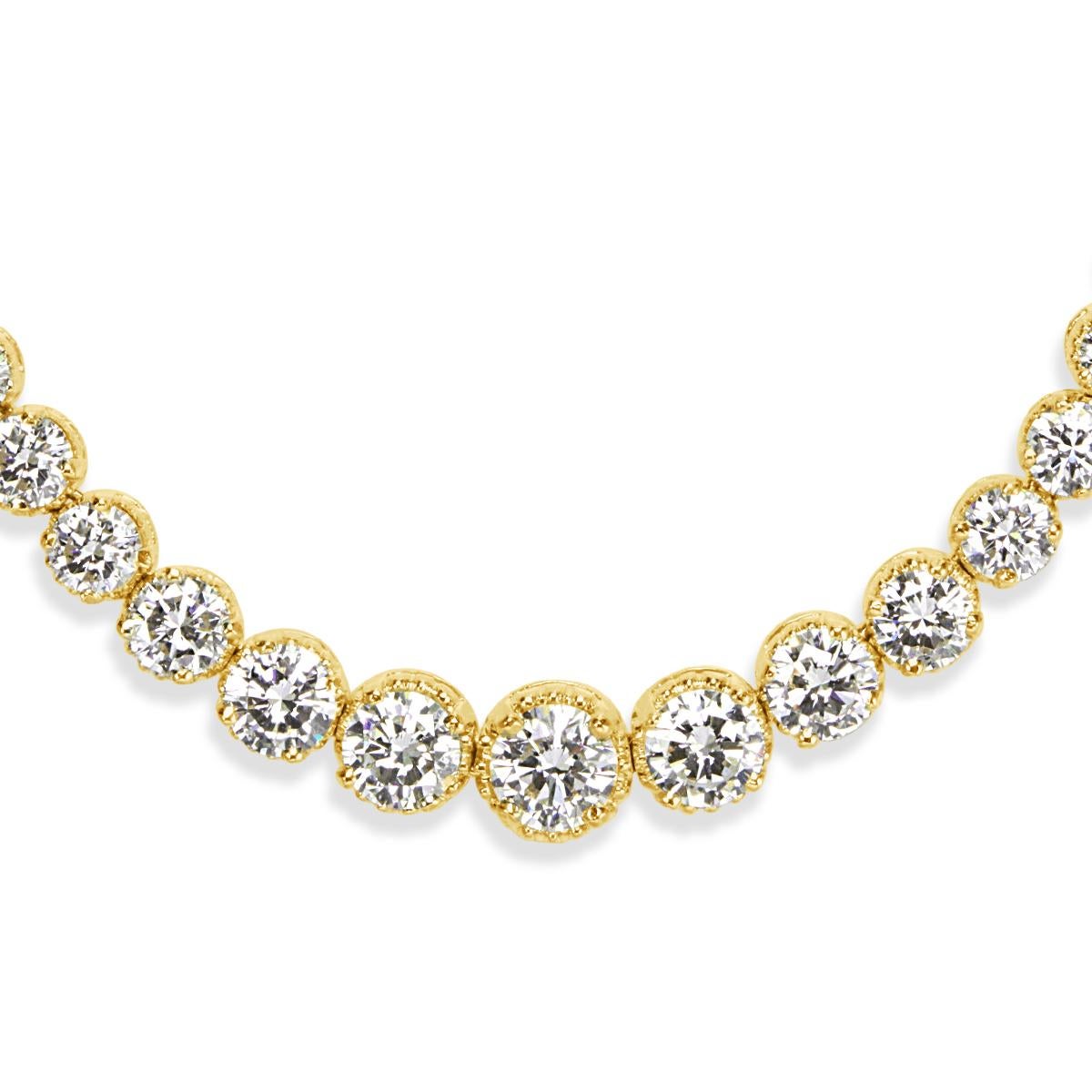 This unique estate diamond necklace features 18.10ct of round brilliant cut diamonds that cascade down the neckline in an elegant 14k yellow gold, riviera setting style. The diamonds are graded at F-G in color, VS1-VS2 in clarity.
