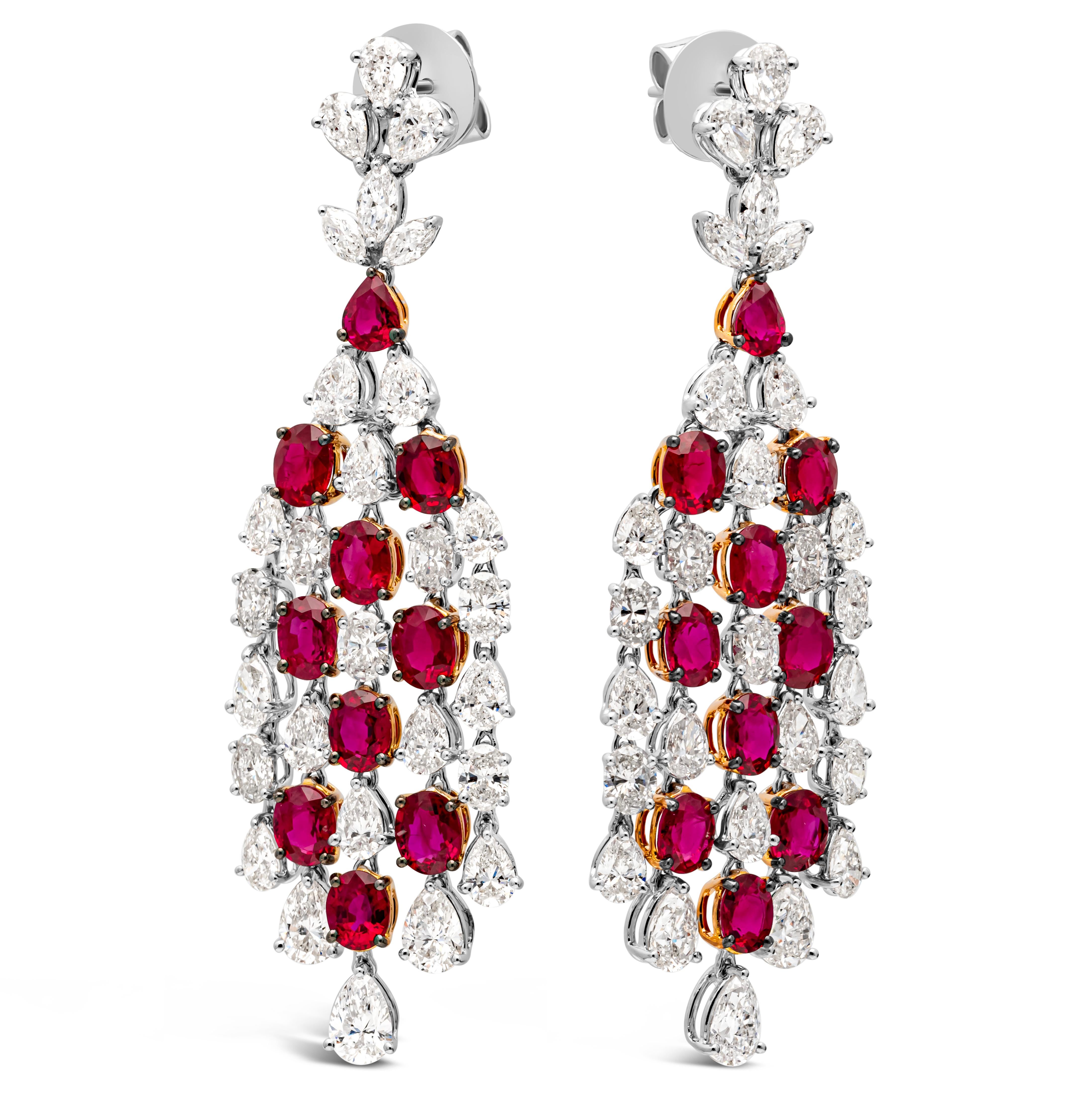 A delicate and exquisite pair of chandelier earrings, showcasing 18 oval cut and 1 pear shape color-rich rubies weighing 9.00 carats total and 9.10 carats total of brilliant oval, pear, and marquise cut diamonds set on an elegant chandelier