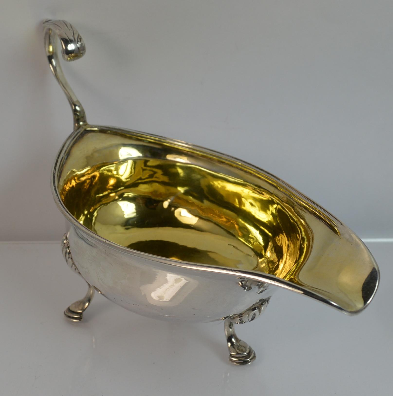 

A beautiful early example of a solid silver sauce boat. True Georgian period piece.

​Stylish boat with a curved handle and standing on three feet. Light gilt insides. 

Tactile and stylish shape.

Hallmarks ; lion, leopard head for London, date