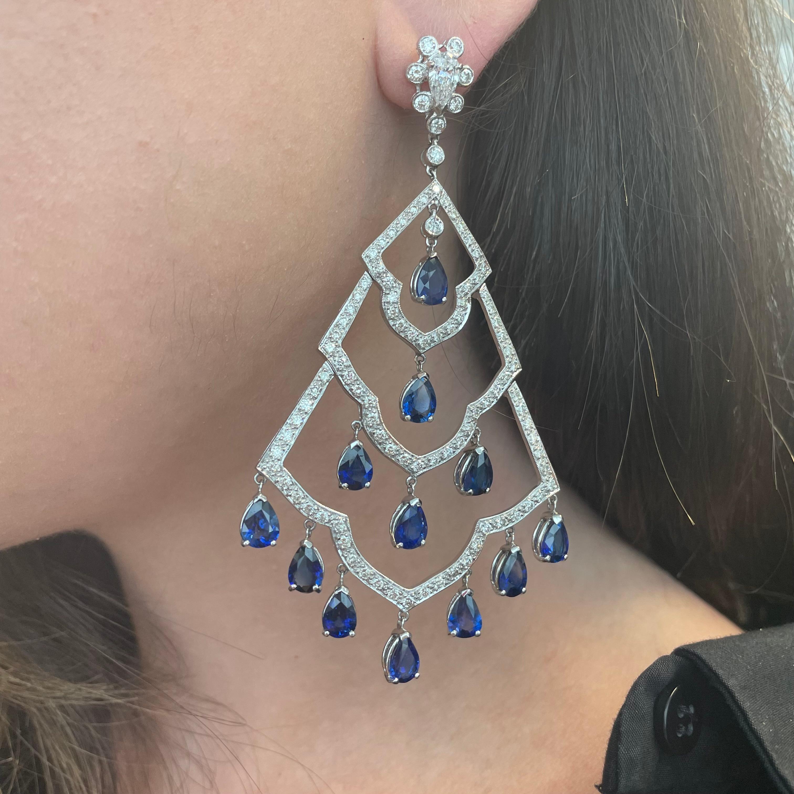 Stunning sapphire and diamond chandelier earrings.
24 pear shape sapphires heat, 18.10 carats. Complimented by 2 pear cut and round brilliant diamonds, 4.26 carats. Approximately G/H color grade and SI clarity grade. Prong set with milgrain work,
