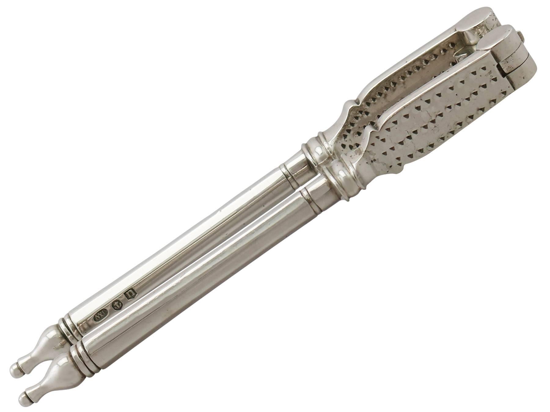 An exceptional, fine and impressive rare pair of antique Georgian English sterling silver nutcrackers; an addition to our silver flatware collection

These exceptional antique George V die cast sterling silver nutcrackers have a plain panelled