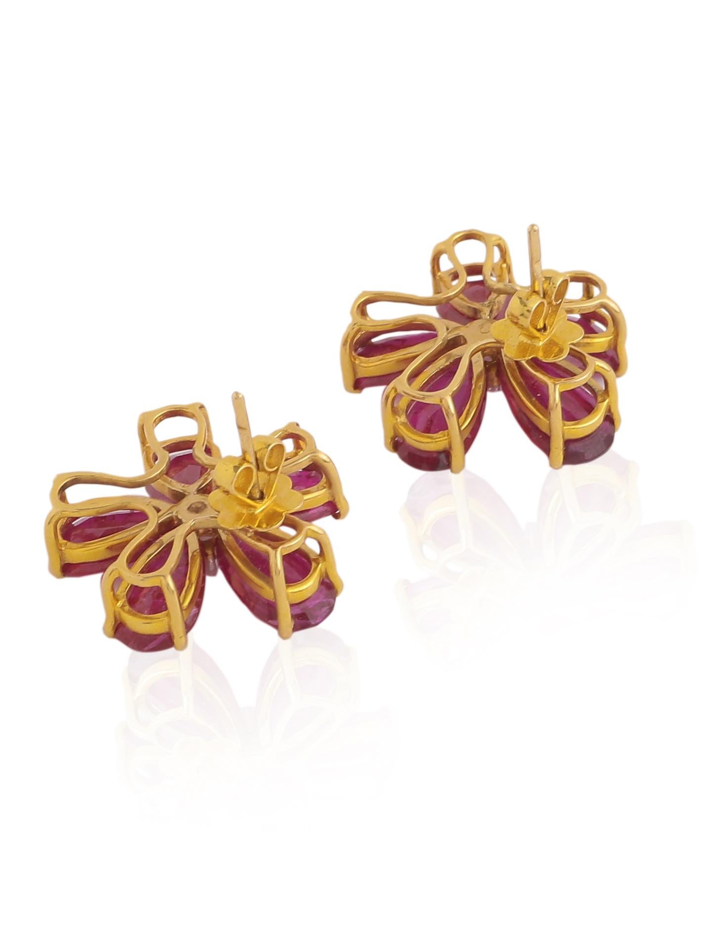 A pair of beautiful Natural Ruby Pears earring with 2 Rose cut diamonds in the centre. The Rubies come from Mozambique and have no treatment in them. The design of the earring is inspired by a flower and the Rubies are set in a way to look like