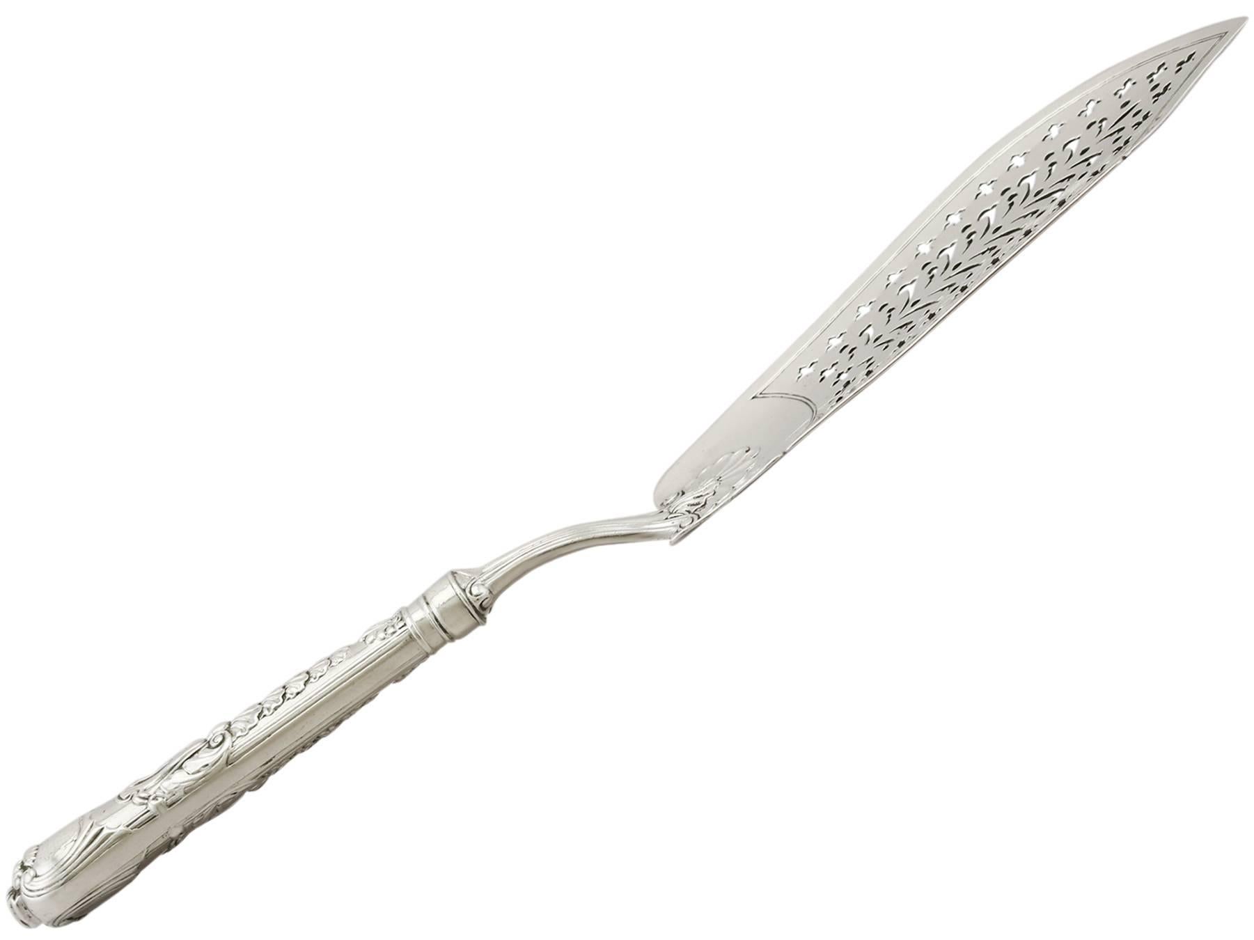 An exceptional, fine and impressive, rare antique Georgian English sterling silver fish slice / server made by Paul Storr; an addition to our silver flatware collection.

This exceptional antique George III sterling silver fish slice / server has