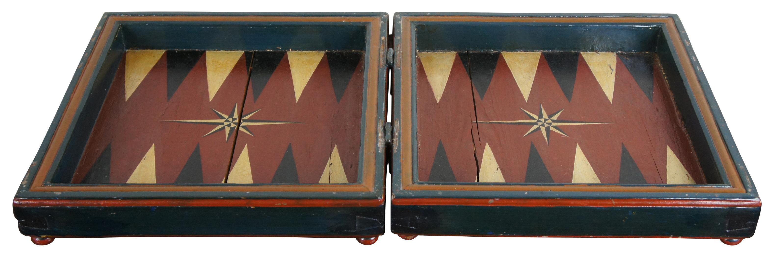 Primitive 19th century antique game board featuring chess, checkers, backgammon and nine man morris. The board is hand painted and detailed anno 1817, footed on both sides with bun feet and opens to backgammon playing surface. Measure: 17