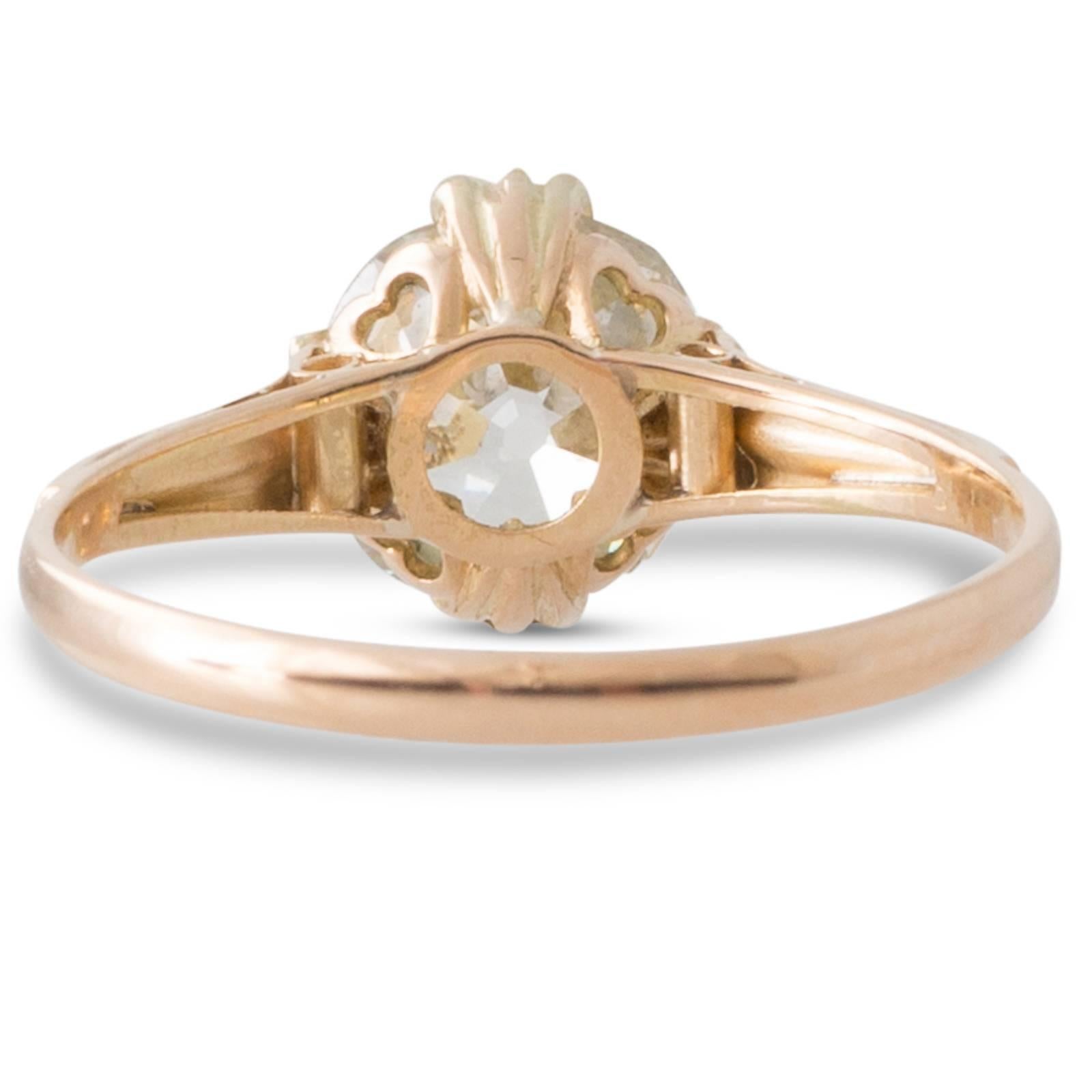 18ct yellow gold antique solitaire ring with a GIA certified 1.81ct cushion cut diamond graded as colour M clarity VS2 set in four triple claws above the heart shaped gallery to upswept grooved shoulders and a plain polished band. Total Diamond