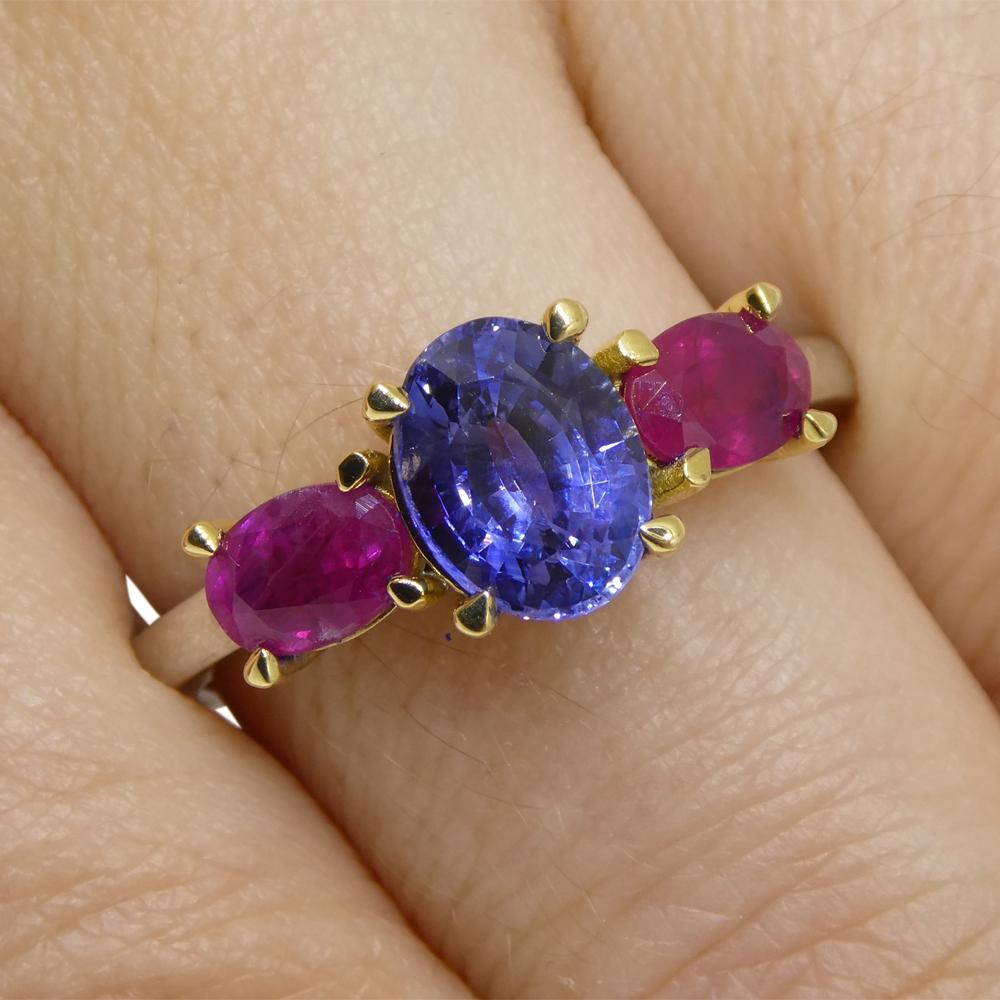 This is a stunning Blue Sapphire Ring, set with rubies in an 18k white and yellow gold setting. 

This ring is made in Toronto, Canada, and is incredibly fine quality!

 
Gem Type: Sapphire
Number of Stones: 1
Weight: 1.81 cts
Measurements: 7.95 x