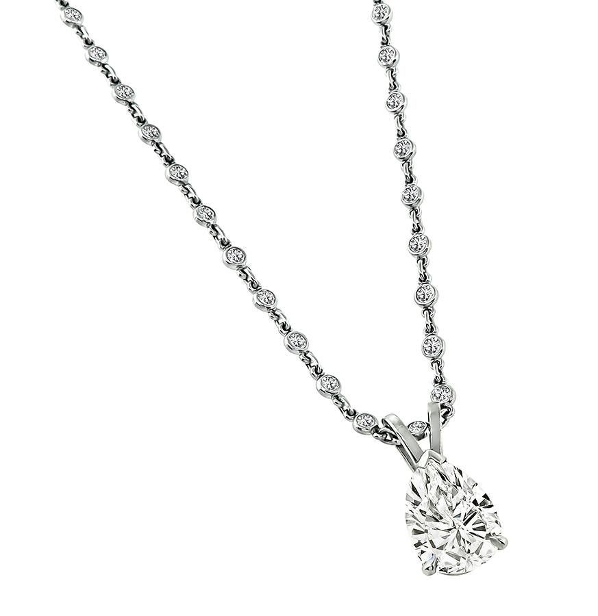 This is a charming platinum pendant necklace. The pendant is set with sparkling pear shape diamond that weighs approximately 1.81ct. The color of the diamond is J with SI1 clarity. The by the yard chain is set with sparkling round cut diamonds that