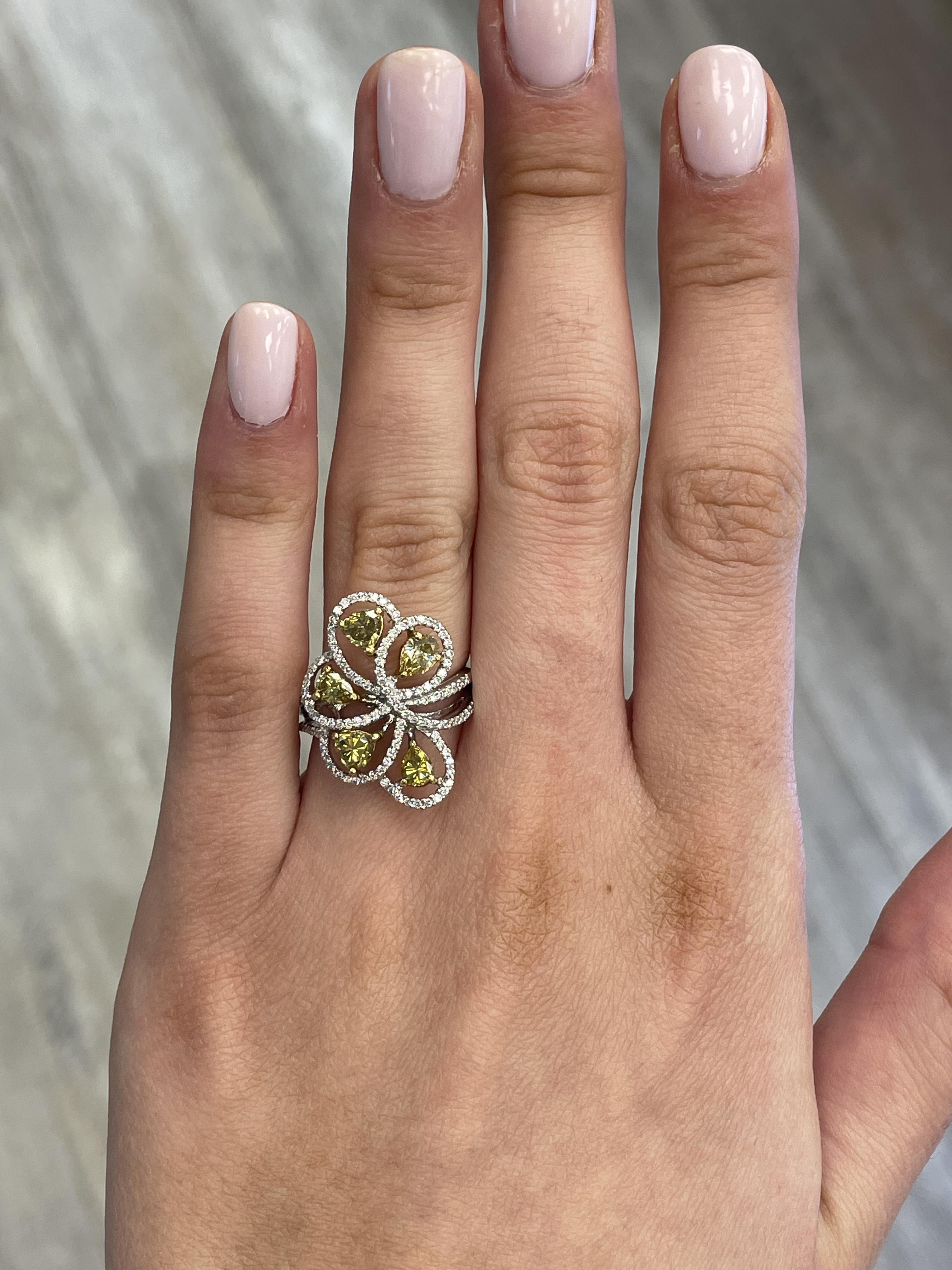 Lovely yellow diamond floral ring.
1.81 carats total diamond weight.
5 mixed diamonds, 1.36 carats. Approximately Fancy Brownish Yellow color diamonds SI clarity. Complimented by 122 round cut diamonds, 0.45 carats total. Approximately G/H color and