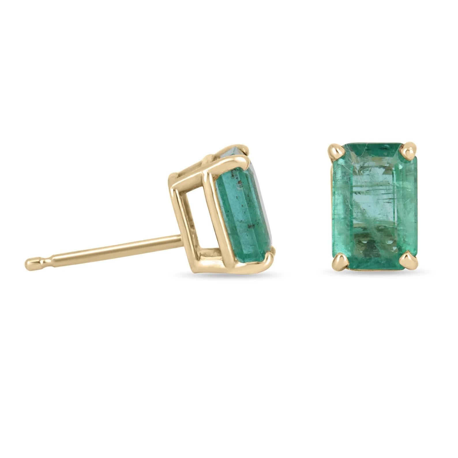 Featured here is a beautiful set of emerald cut emerald studs in fine 14K yellow gold. Displayed are dark green emeralds with very good transparency, accented by a simple four-prong 14K gold mount, allowing for the emerald to be shown in full view.