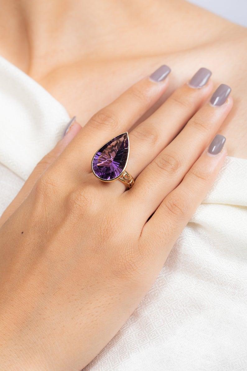 This ring has been meticulously crafted from 14-karat yellow gold and set with 18.2 carat amethyst.

The ring is a size 7 and may be resized to larger or smaller upon request. 
FOLLOW  MEGHNA JEWELS storefront to view the latest collection &