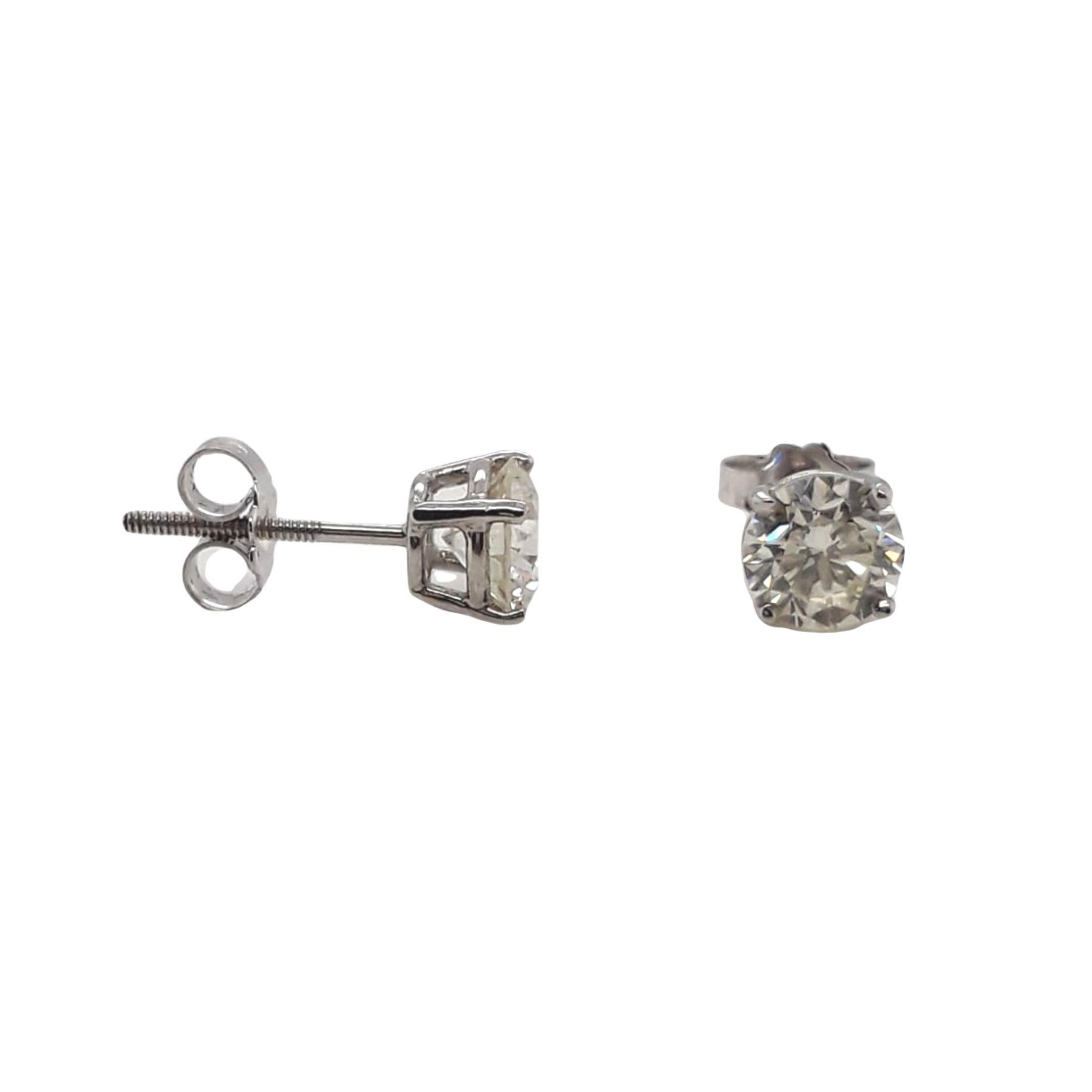 Diamond Stud Earrings made with natural brilliant cut diamonds. Total Weight: 1.82 carats, Stone Diameter: 6.18 x 6.15, Color: J-K, Clarity: VS1-VS2. Set on a 4 prong mounting in 18 karat white gold, screw back setting. 