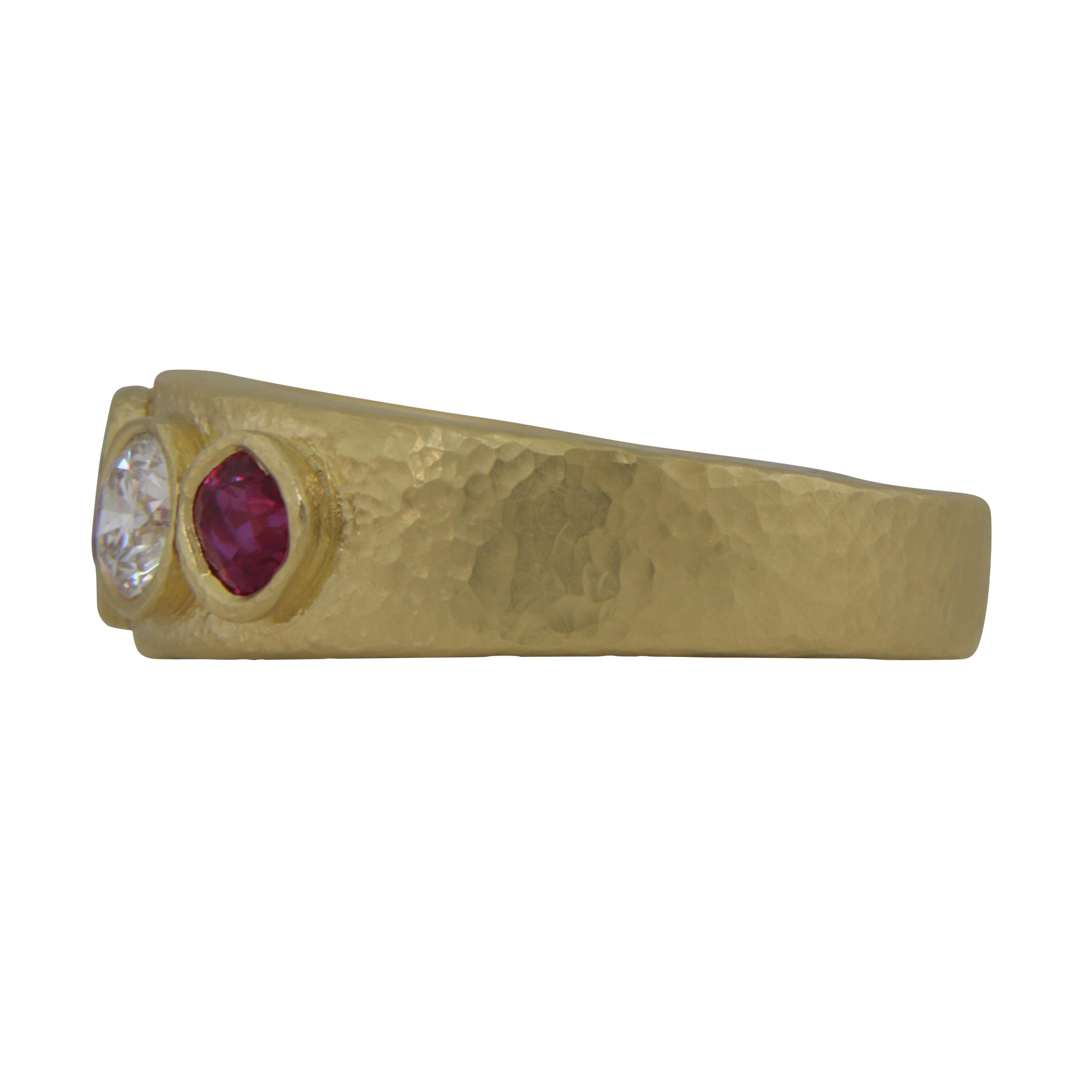 Featured is a hand crafted 18 karat yellow gold diamond & ruby ring with 2 round brilliant diamonds weighing 0.62 carats and 3 ruboie's weighing 1.20 carats 9.60 grams finished with a lightly hammered brushed texture size 6.50 USA 

- Size is