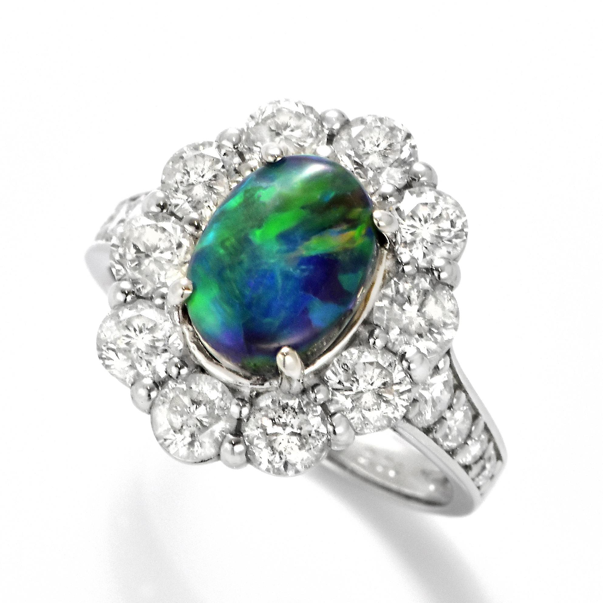 A beautiful ring featuring a 1.82 Carat, Natural, Australian Black Opal and 2.20 Carats of Diamond Accents set in Platinum. The Opal displays very good play of color! Opals are known for exhibiting flashes of rainbow colors known as 