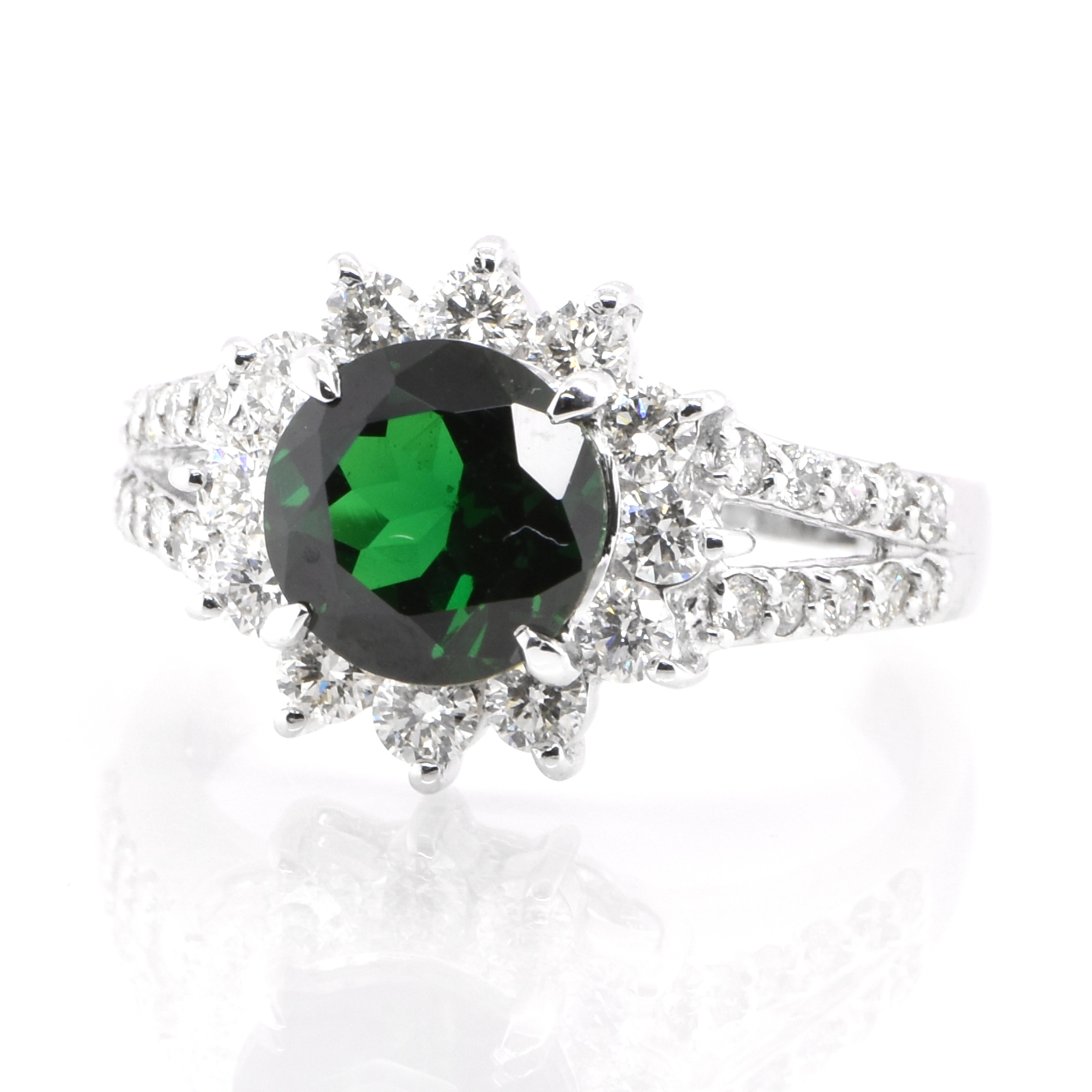 An absolutely gorgeous ring featuring a 1.825 Carat, Natural Tsavorite Garnet and 0.77 Carats of Diamond Accents set in Platinum. Garnets have been adorned by humans throughout history from Ancient Egypt, Rome and Greece. They come in a wide variety