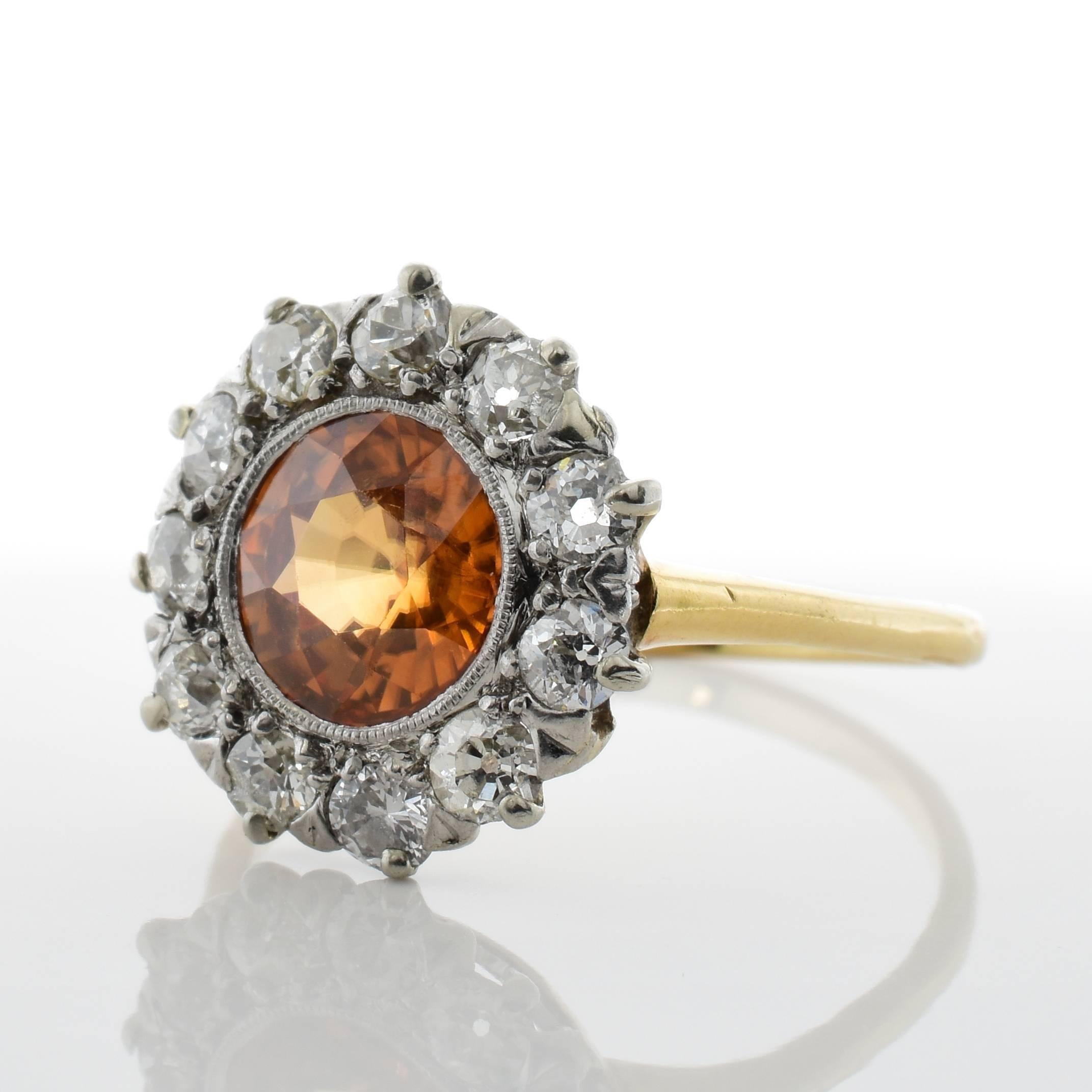 This antique ring features a 1.82 carat zircon center stone, surrounded by 1.50 carats of Old European cut diamonds, which are set in 14k yellow gold. 
