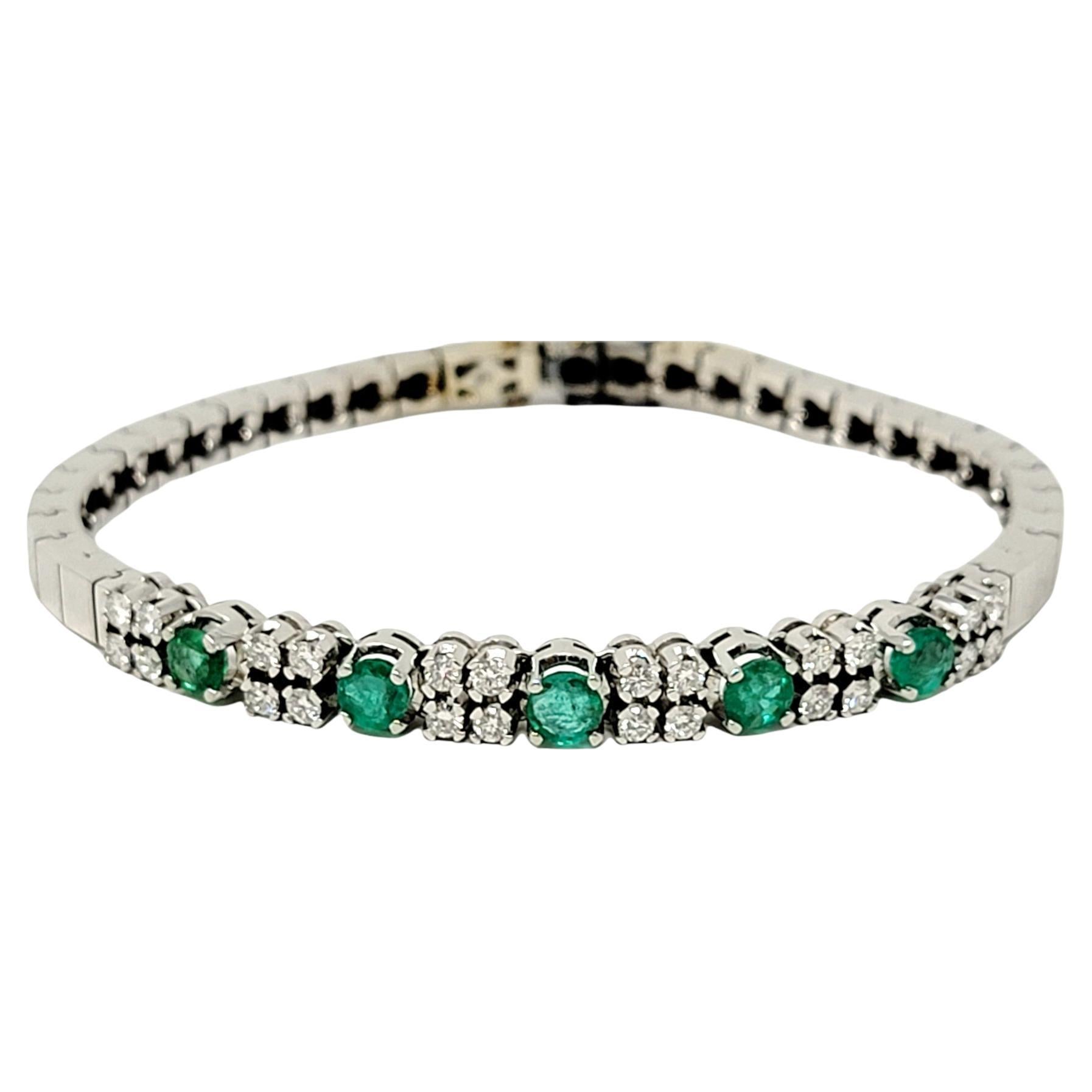 Vibrant green emeralds and sparkling natural diamonds make this stunning bracelet absolutely pop! Lightly textured brushed white gold links surround the beautiful center focal point of glittering gemstones, while the flexible style comfortably wraps