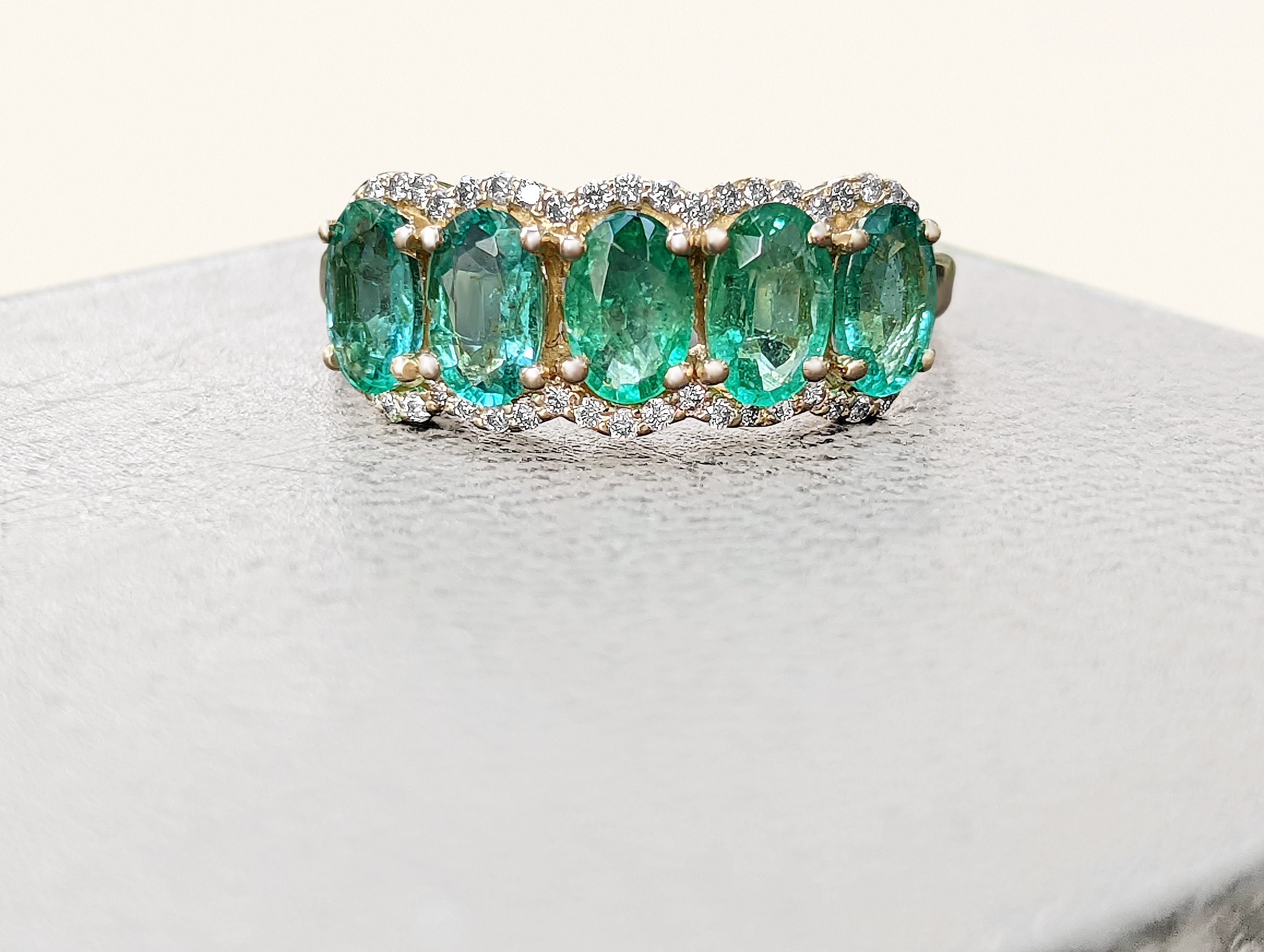 Ring can be sized free of charge prior to shipping out.

Center Stone:
___________
Natural Emerald
Cut: Oval Mixed
Carat: 1.82 ctw, 5 stones
Color: Green

Side Stones:
___________
Natural Diamonds
Cut: Round 
Carat: 0.20 tccw / 50 stones
Color: