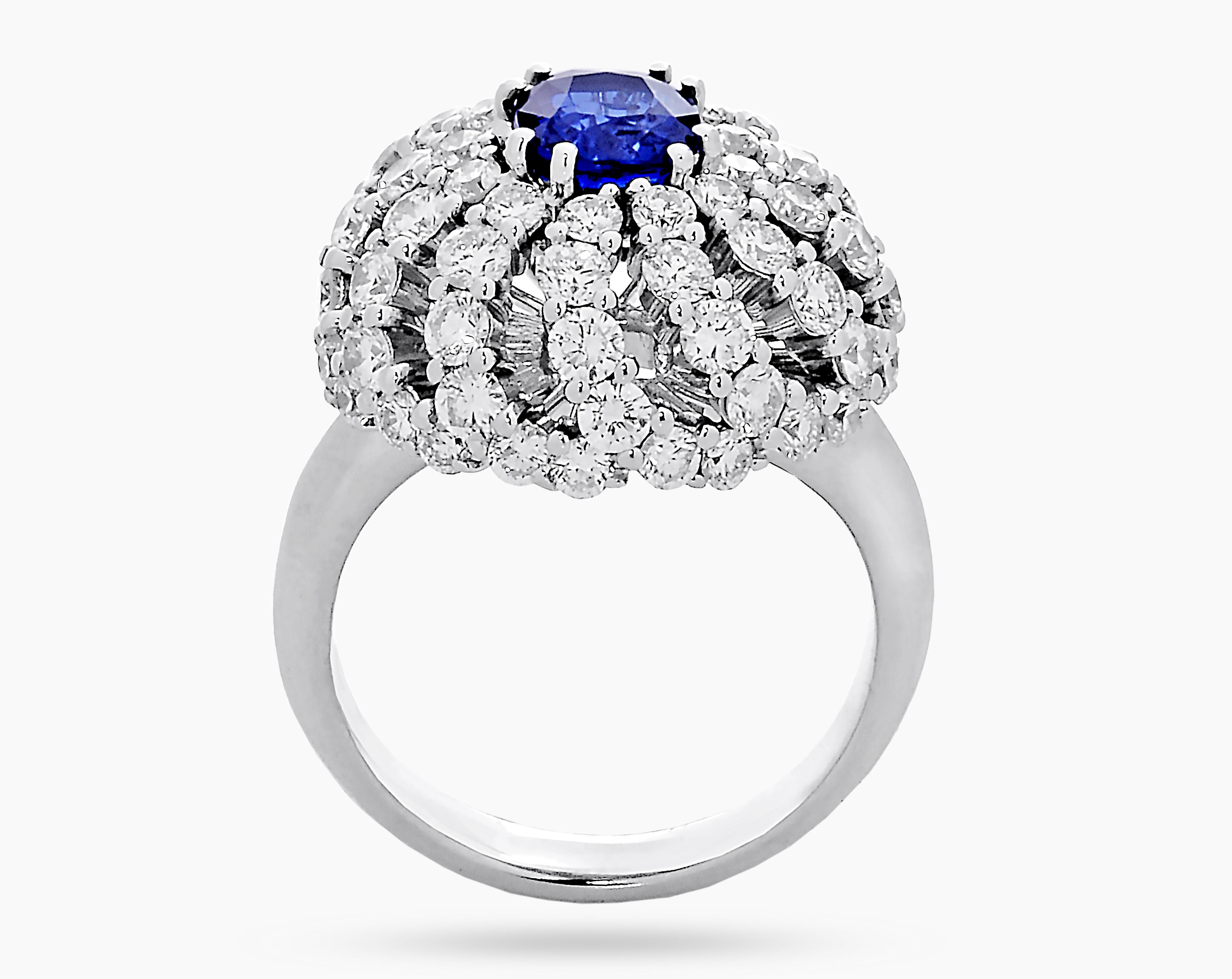 A masterpiece of Italian artistry is this dome shaped ring in 18k white gold. It features a beautiful cushion shaped 1.82 carat Natural Royal Blue Sapphire in the center that is surrounded by 72 F/G-VVS/VS diamonds, totalling 3.37 carats. 

Based on