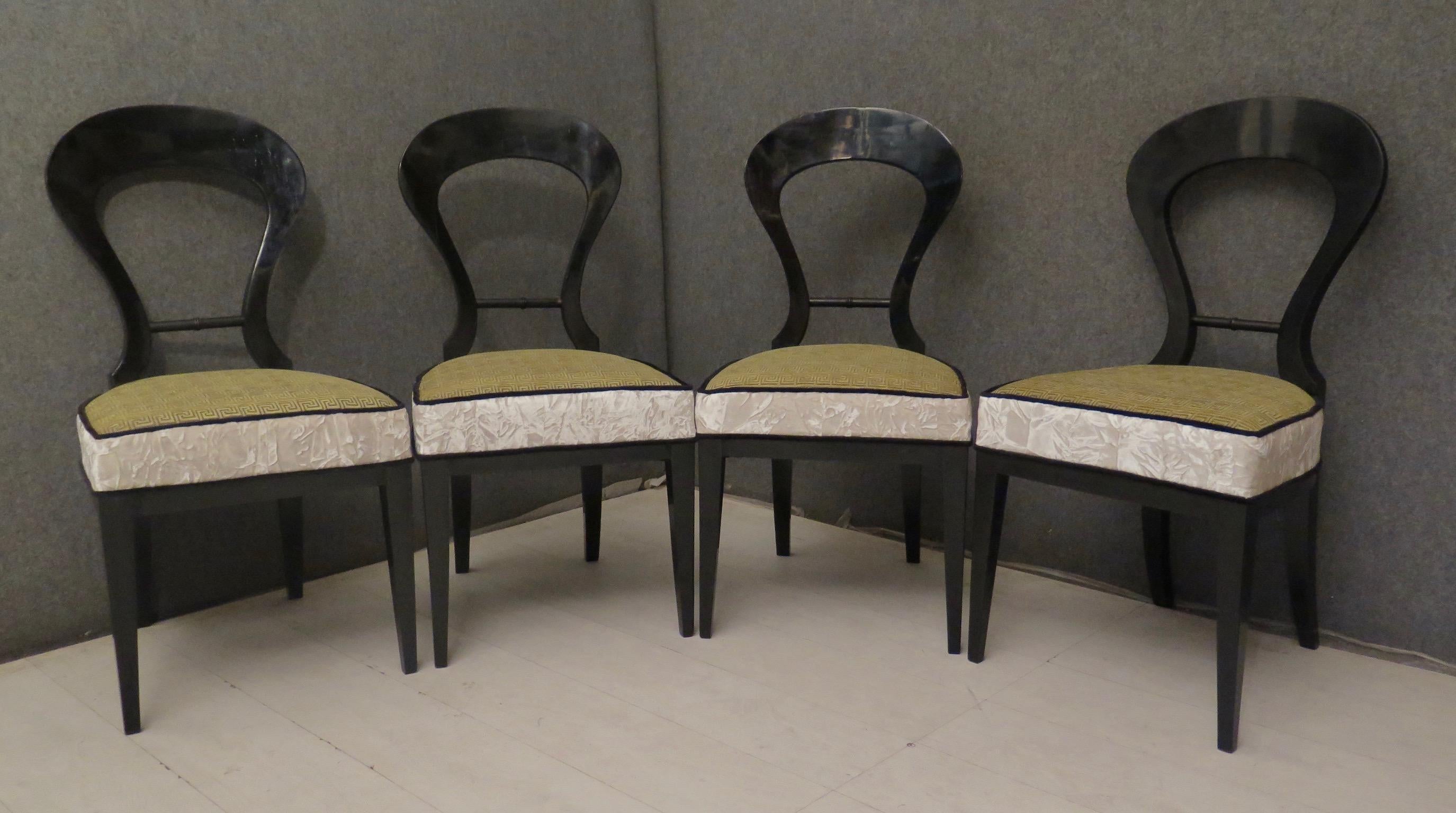 Four 1830 Biedermeier chairs. The four chairs are polished in black shellac, their backrest is round in shape, with a cross section in the middle. The seat, Classic of that period, is straight in the front, and on the two sides tends to curve