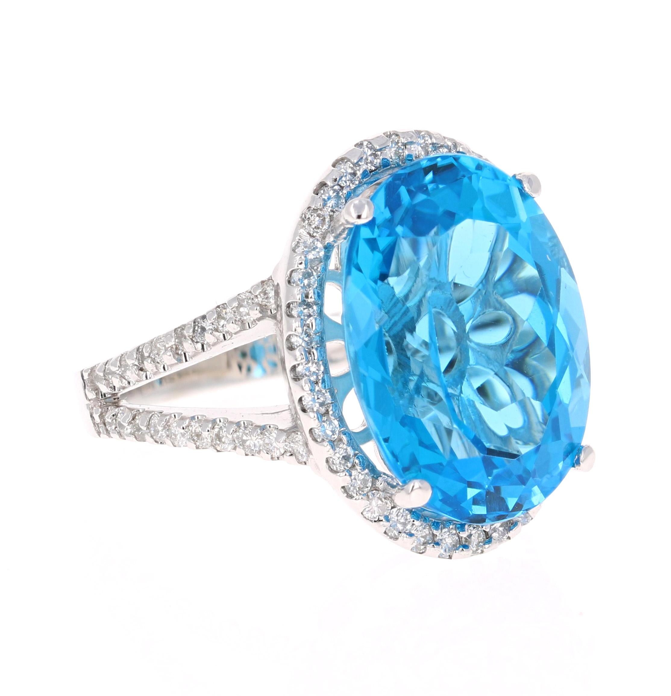 This stunning statement ring has a large Oval Cut Blue Topaz that weighs 17.27 Carats. 
It is surrounded by a simple halo of 76 Round Cut Diamonds that weigh 0.93 Carats. 

It is crafted in 14 Karat White Gold and weighs approximately 7.7 grams.