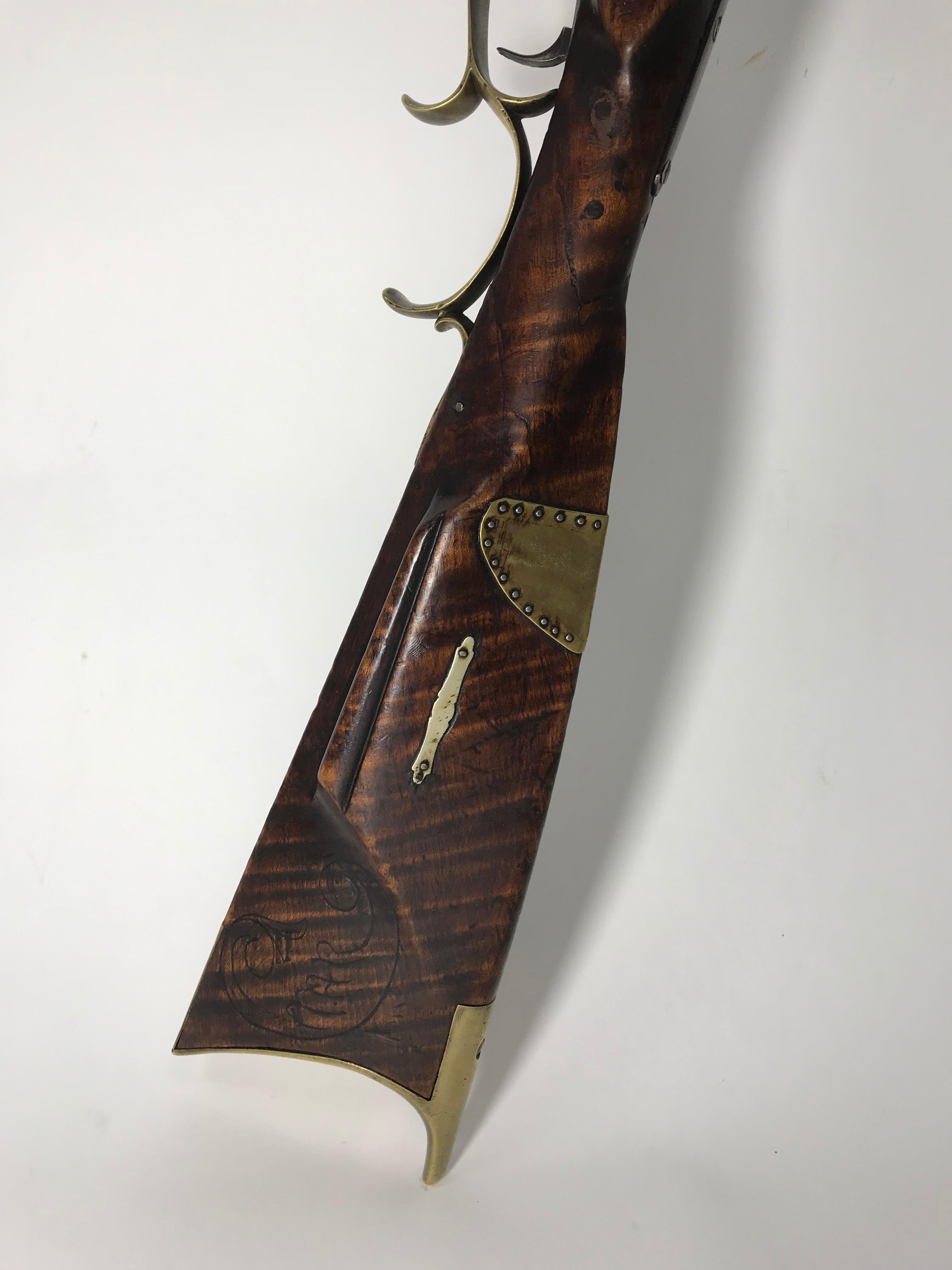 A superb example of an early American circa 1820 signed Kentucky Rifle.
Rare for these rifles to be found intact with the maker having made and signed both lock and barrel. Particularly good looking with beautiful lines which can to a degree 
be