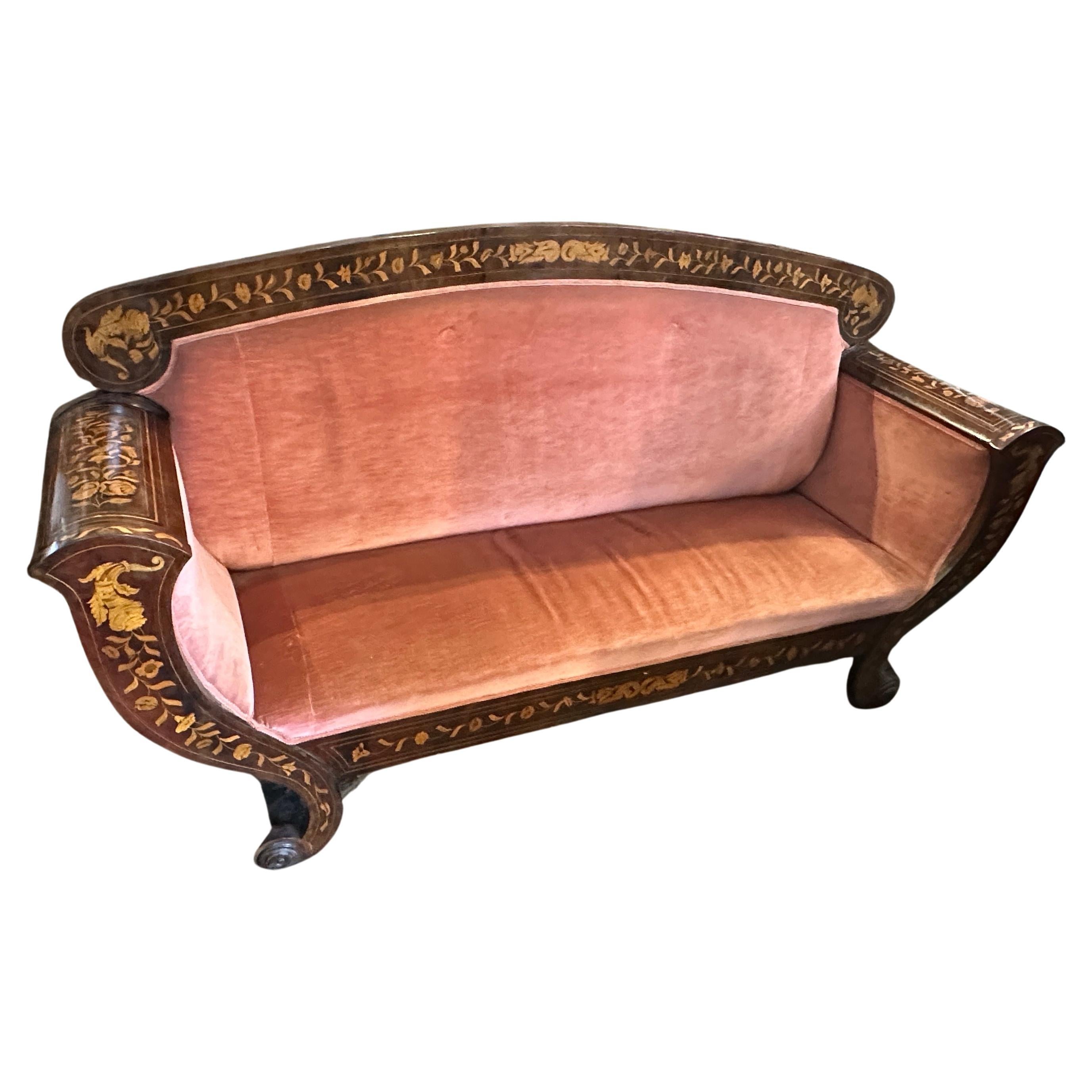 This antique Sicilian sofa has been crafted during the reign of Charles X. The sofa is notable for its elegant design, featuring intricate inlaid wood that likely displays detailed floral or geometric patterns, a common characteristic of furniture