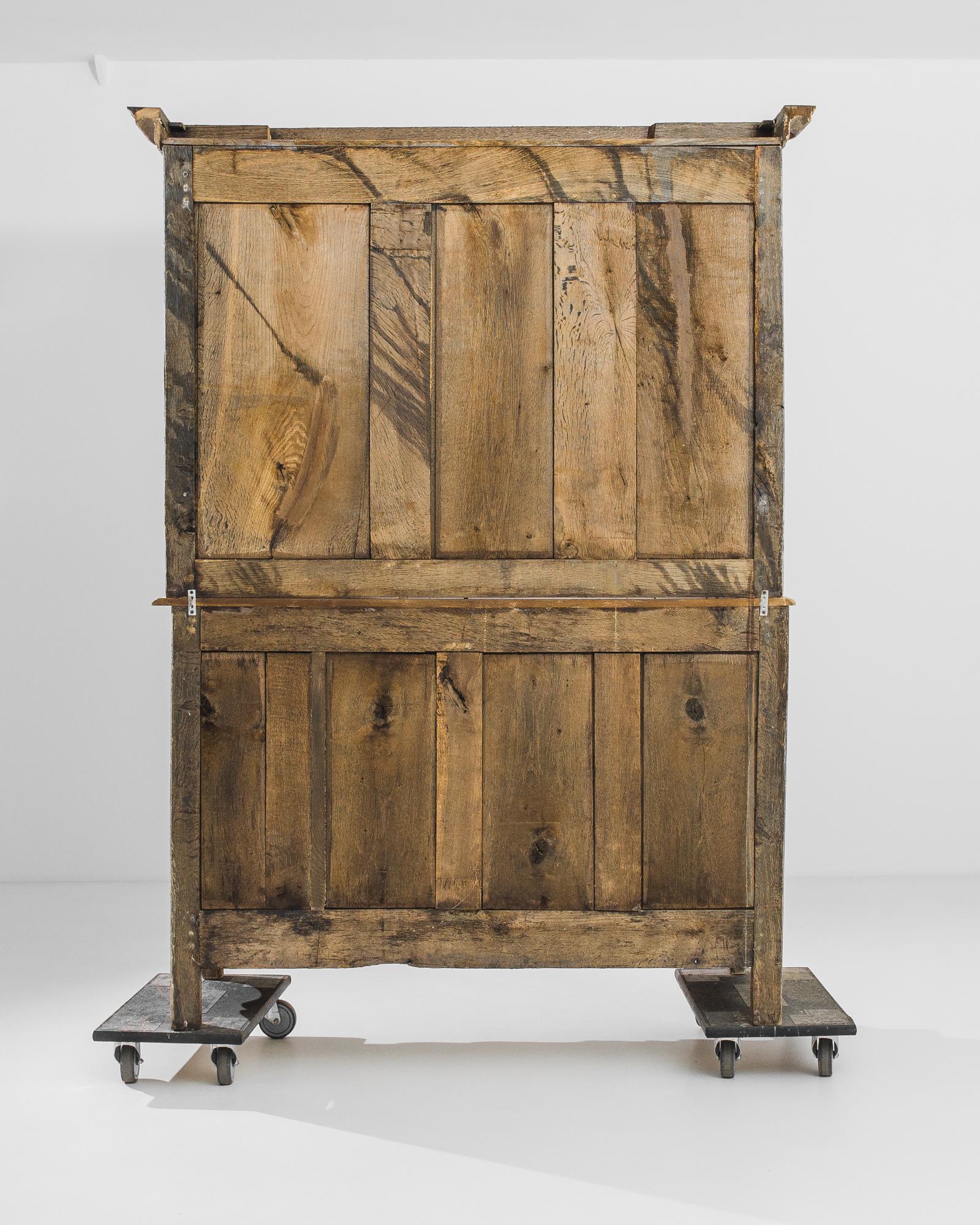A bleached oak cupboard from France, produced circa 1820. A gorgeous antique certain to inspire childhood memories of inspecting shelves stuffed with knick-knacks that seem to stretch to the sky. In this rustico-chic iteration of this classic