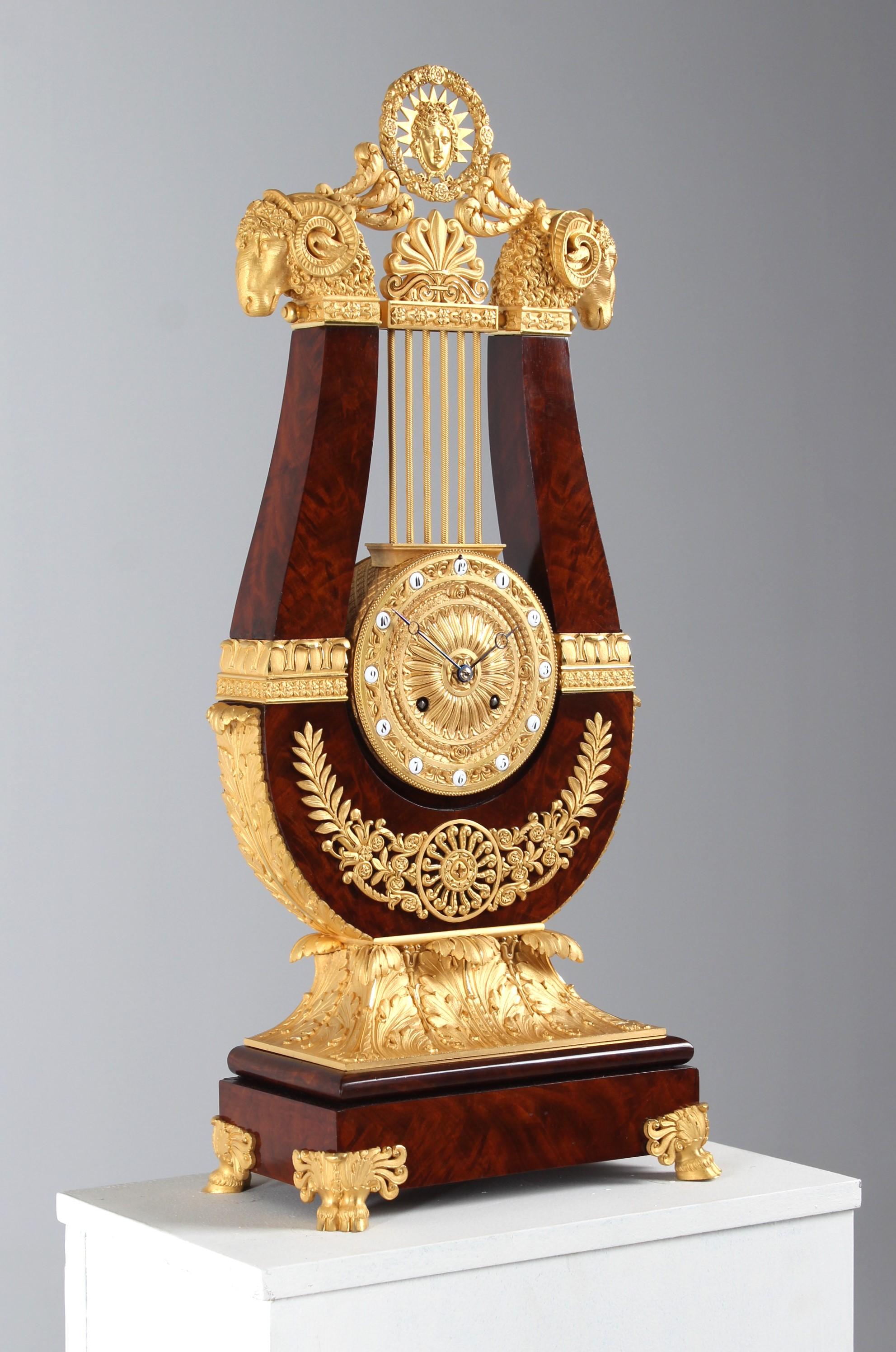 Large Lyra Pendule

Paris
circa 1820

Dimensions: H x W x D: 64 x 28 x 15 cm

Description:
The base stands on feet designed as ram's hooves. The lyre, symbolising Apollo, the god of light and music, is held up by acanthus leaves with numerous bronze