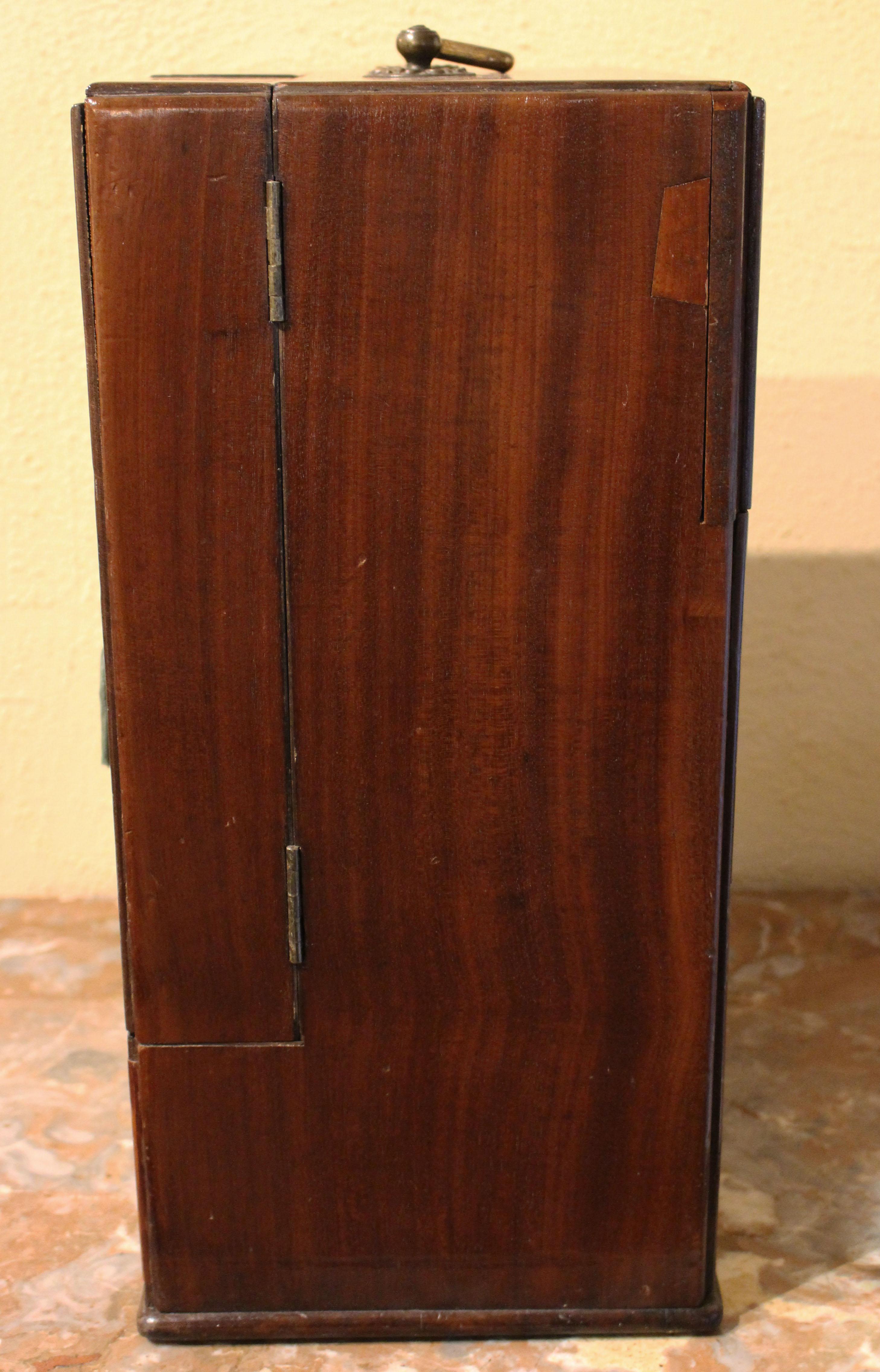 A superb Apothecary Chest of mahogany with ebony trim. English, George III, c.1820. Containing a large array of period bottles - note how each cubby is lined with soft fabric covers. The back panel slides open to the poison bottles to prevent an