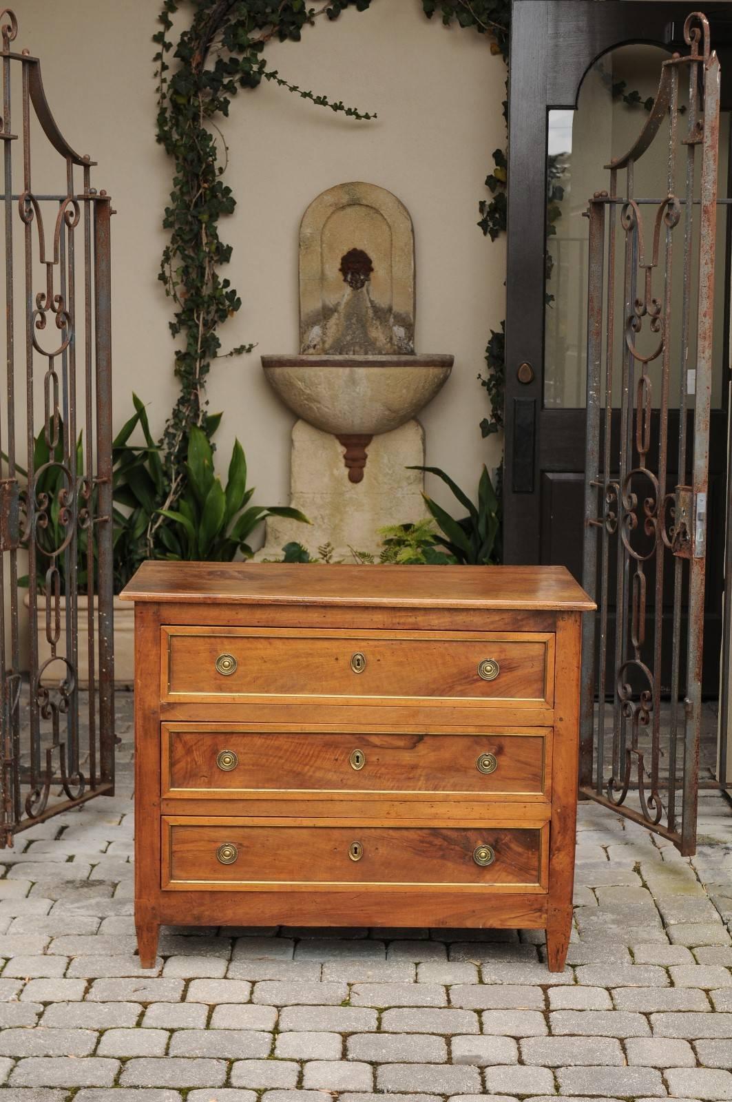 Gilt 1820s Neoclassical Period French Three-Drawer Walnut Commode with Brass Trim