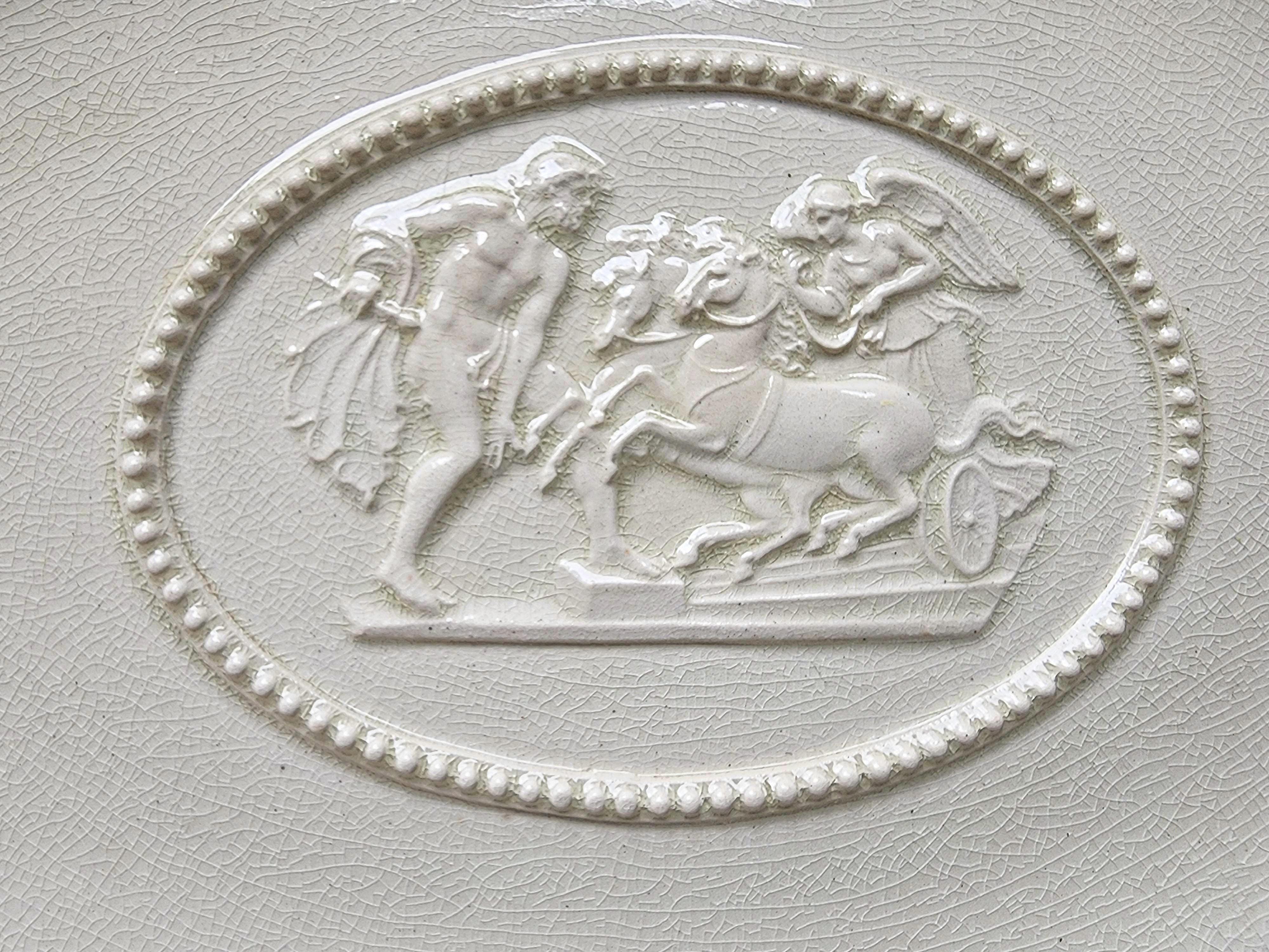 Rare form antique, early 19th c. English creamware dish by Wedgwood. With a pierced and reticulated border and a central relief reserve showing a classical scene of an angel driving a chariot perhaps 