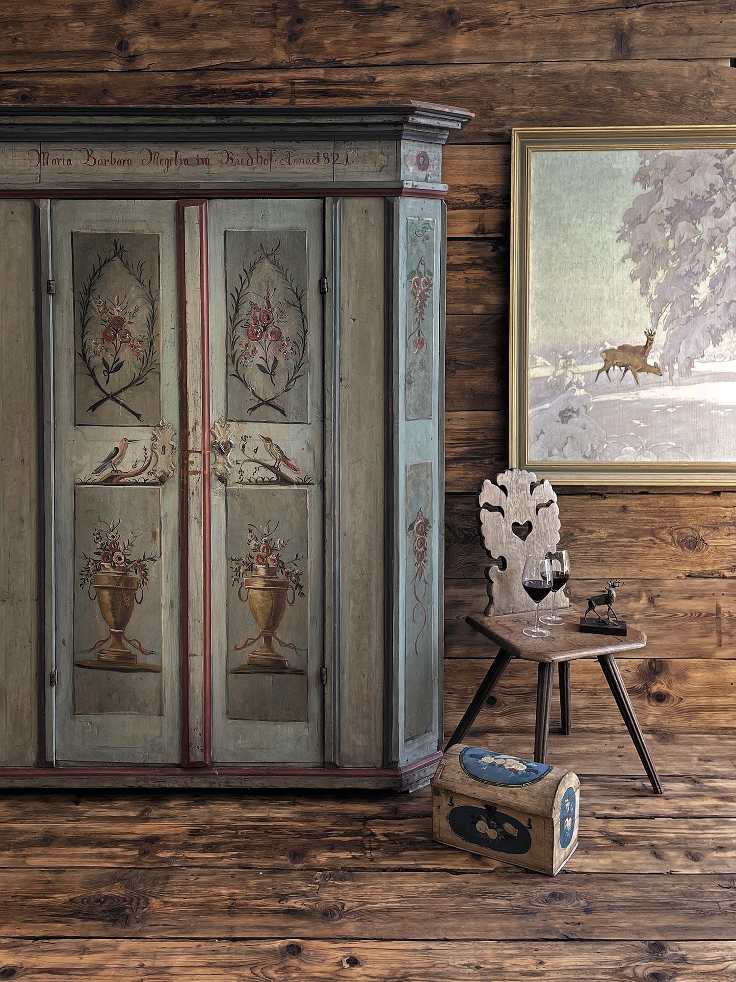 Painted cabinet dated 1821
CODE: A198
H. 192cm – L. 141 cm (155 at the frames) – P. 46cm (54 at the frames)

Painted wardrobe, entirely made of fir wood and painted light blue. Floral decorations are depicted on the two doors, contained in rich cups