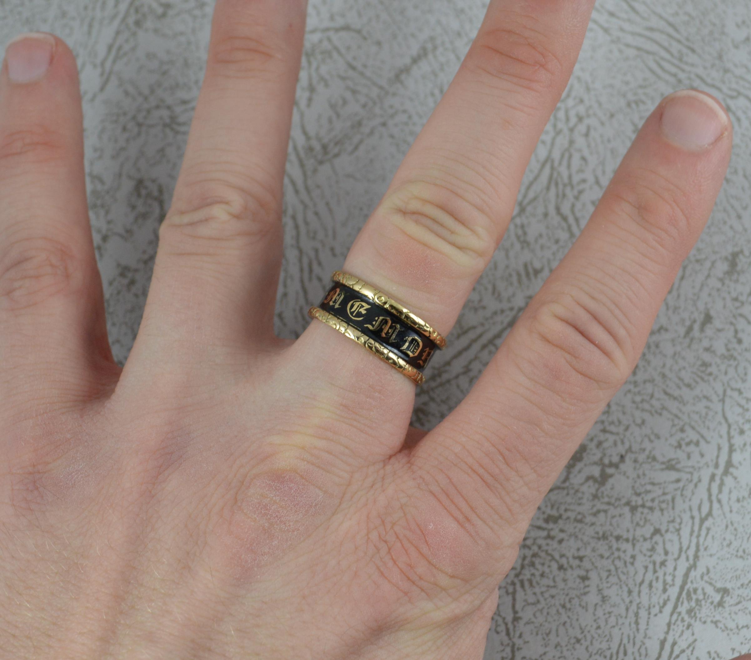 A Georgian period mourning band or stack ring in 18ct Gold.
8.1mm wide throughout.
Enamelled centre piece, In Memory Of. With deep floral relief to the edges.
A pretty design with fine engraving to inside. C Wales, died 30 Dec 1836, aged