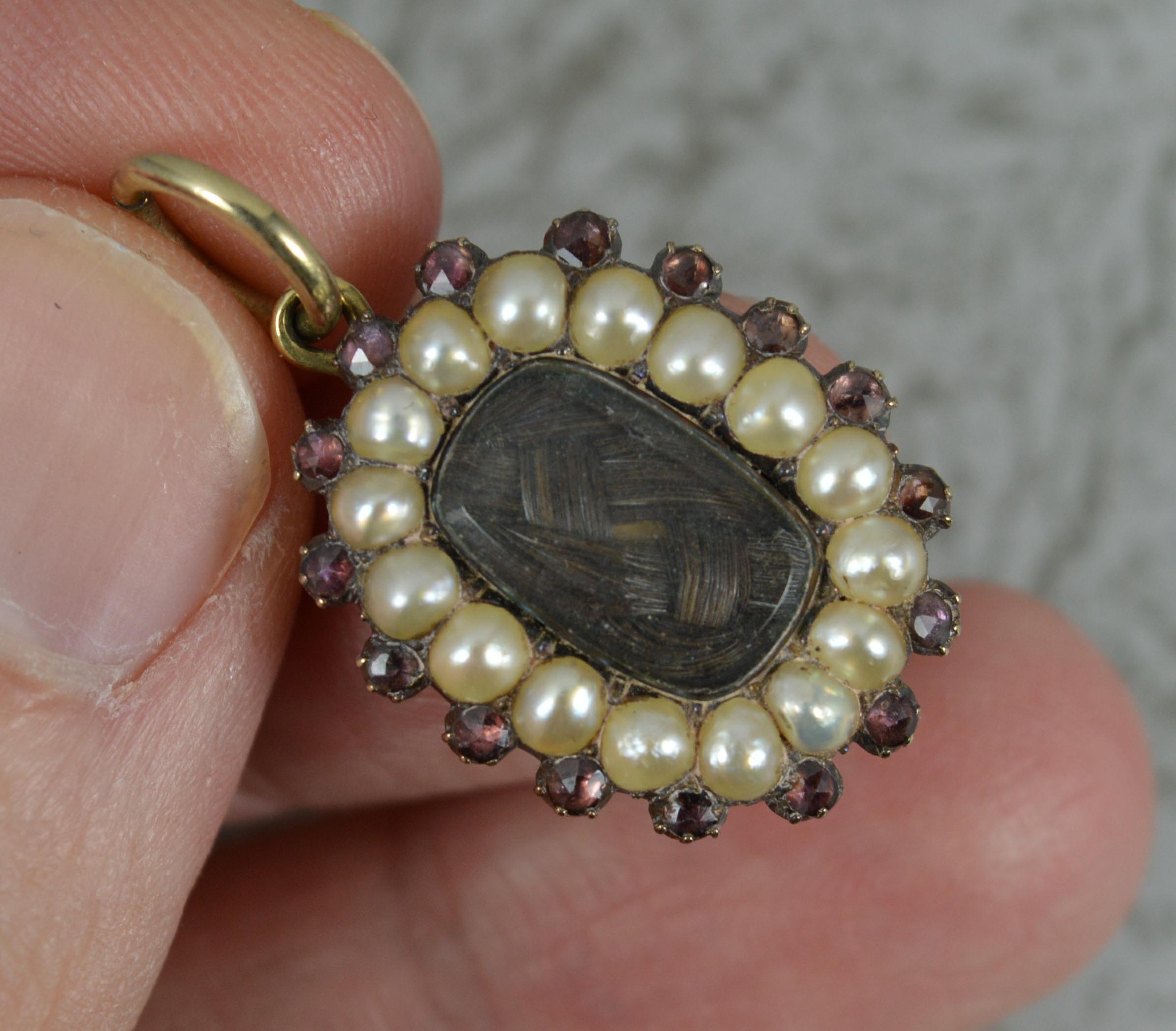 A superb Georgian period mourning pendant.
Solid gold example.
The front holds a locket containing hair to centre with full border of pearls and outer border of garnets.
The reverse with full engraving confirming 1826 period.

CONDITION ; Very for