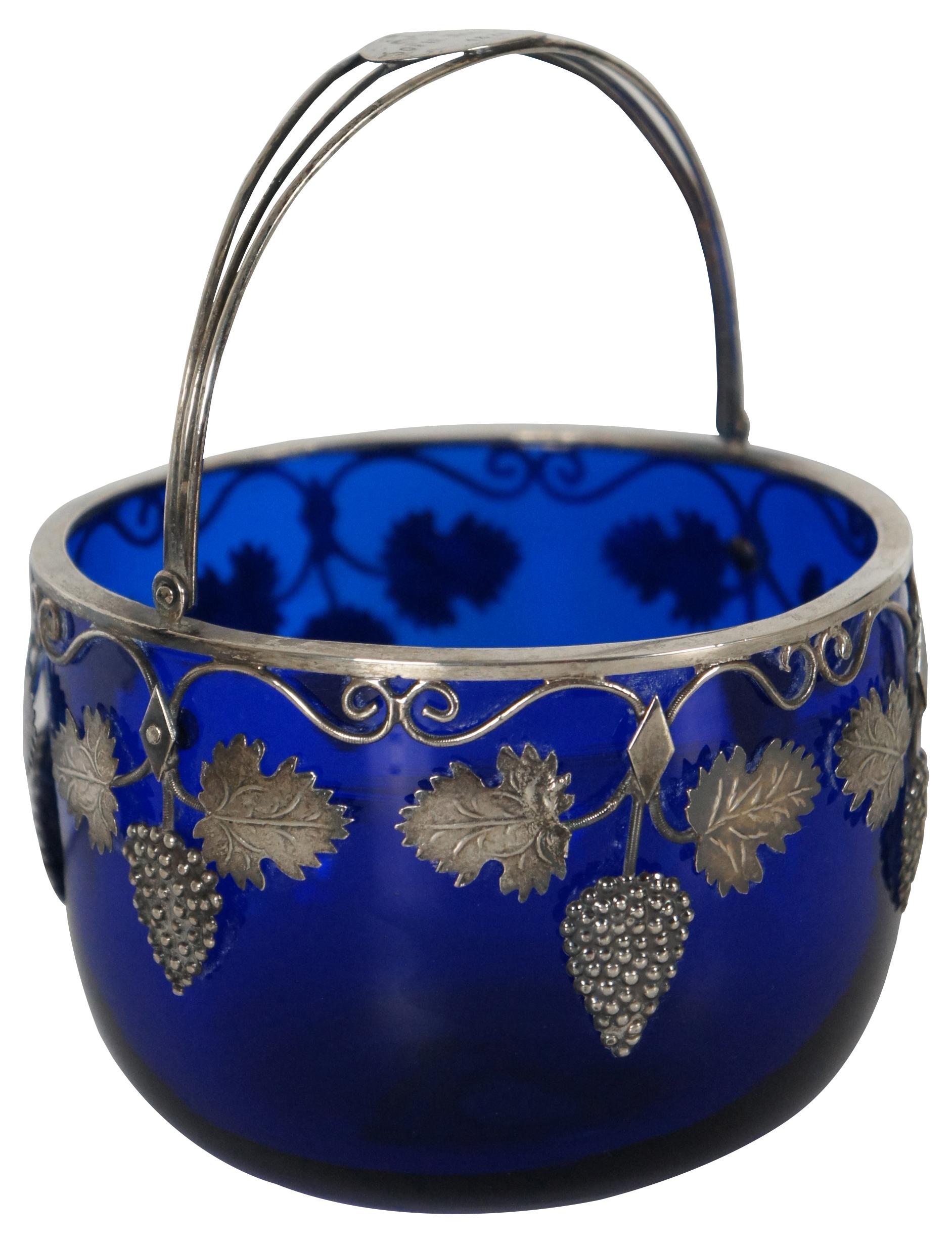 Antique European hand blown Georgian / Edwardian cobalt blue glass candy basket or sugar bowl with sterling silver 925 handle and strawberry leaf design, engraved with “Sophie Nodskov 1 April 1828.”

Measures: 4.5” x 3.375” / height of handle –