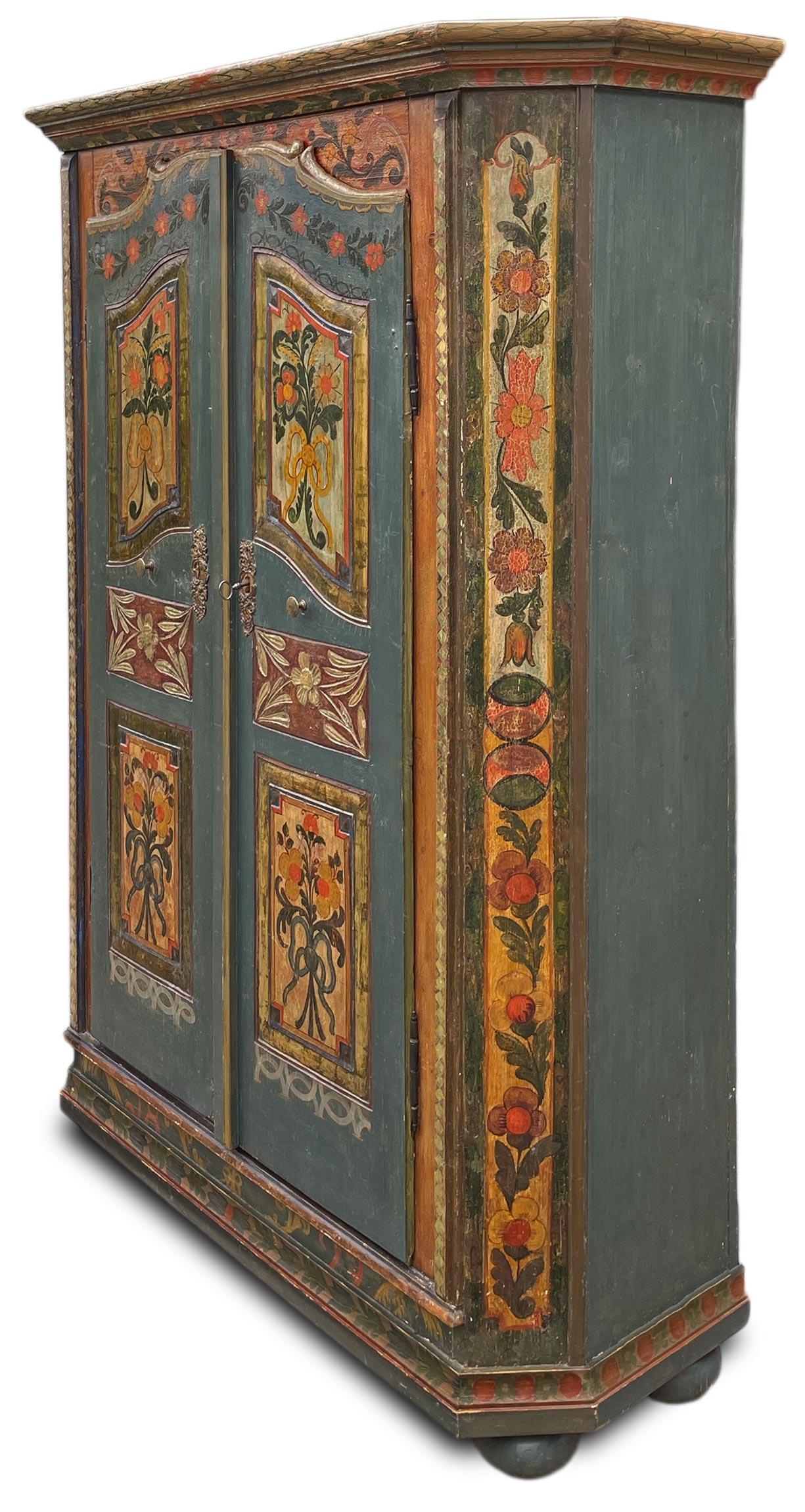 Tyrolean Painted Wardrobe with Floral Motifs - 1829

Technical information:
Period: 1829
Origin: Tyrol
Wood type: Fir

Height: 193 cm  75.98 in
Width: 133 cm (146 cm with frame)  52.36 in (57.48 in with frame)
Depth: 45 cm (52 cm with frame)  17.71