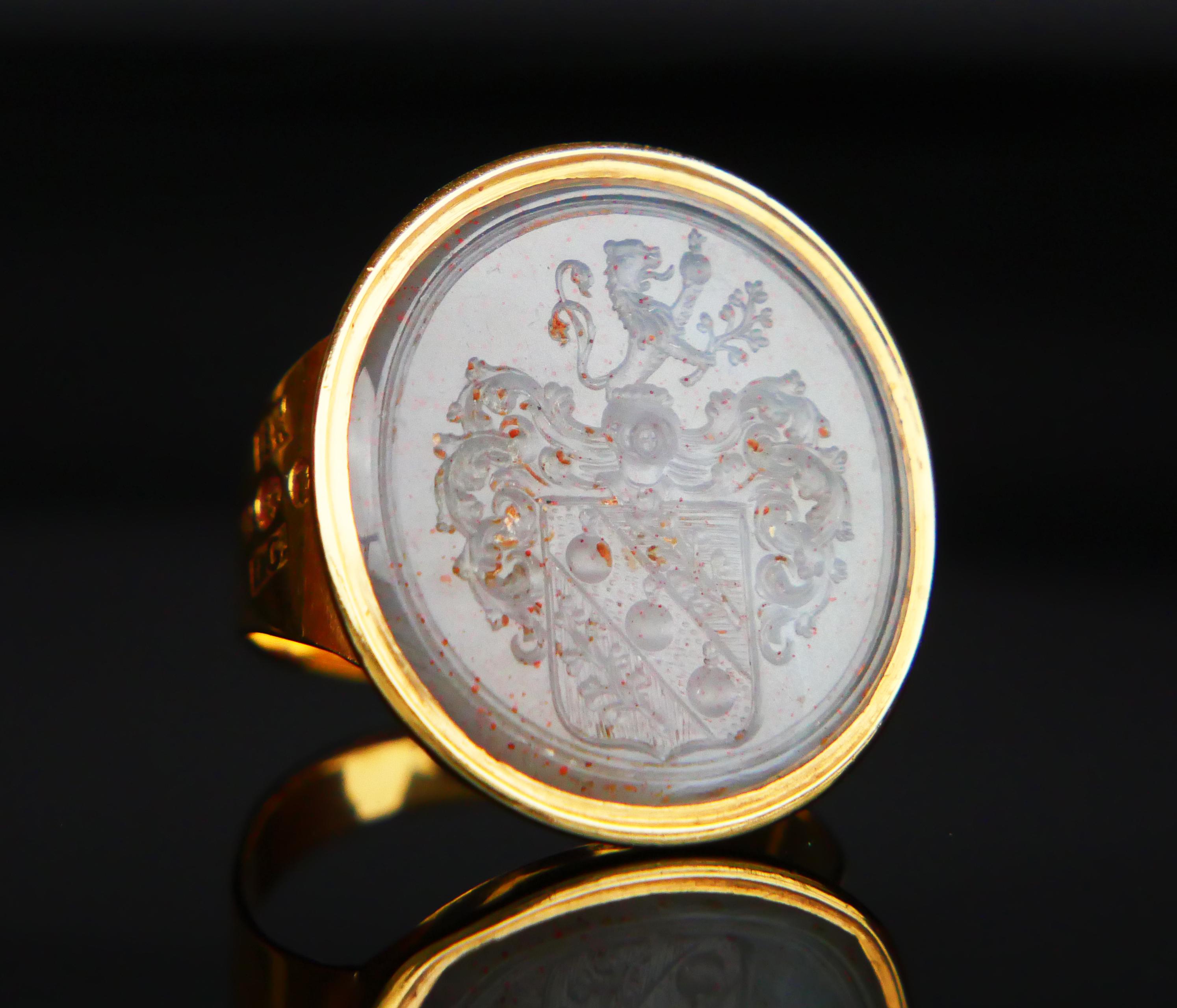 195 years old Signet Intaglio Ring featuring a natural red- spotted Gray - Blue Sardonyx stone with hand-cut heraldic depiction of three smoking Grenades flanked with Lilies on the shield under a Knight's Helmet lavishly decorated with plumage. On