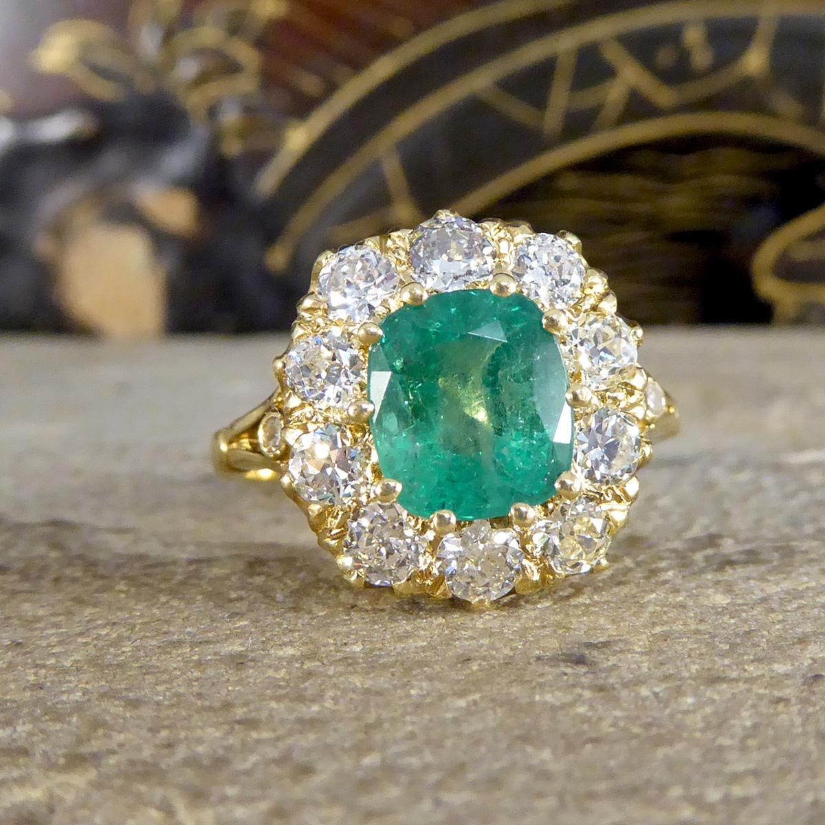 This beautiful ring features an Emerald weighing 1.82ct held securely into place with a ten claw gold setting. The Emerald bright in colour with regular Emerald flaws and is surrounded by 10 Old European cut Diamonds weighing 1.20ct in total, with