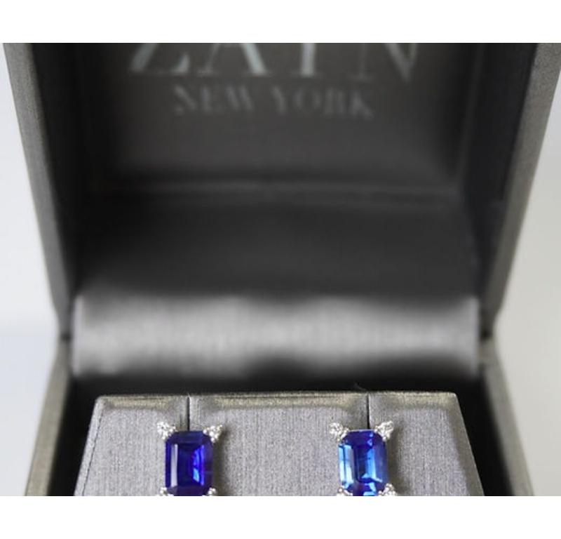 Sapphire Weight: 1.83 CT, Measurements: 7x5 mm, Diamond Weight: 0.07 CT 1.3 mm, Metal: 18K White Gold, Gold Weight: 1.92 gm, Shape: Emerald-Cut, Color: Blue, Hardness: 9, Birthstone: September