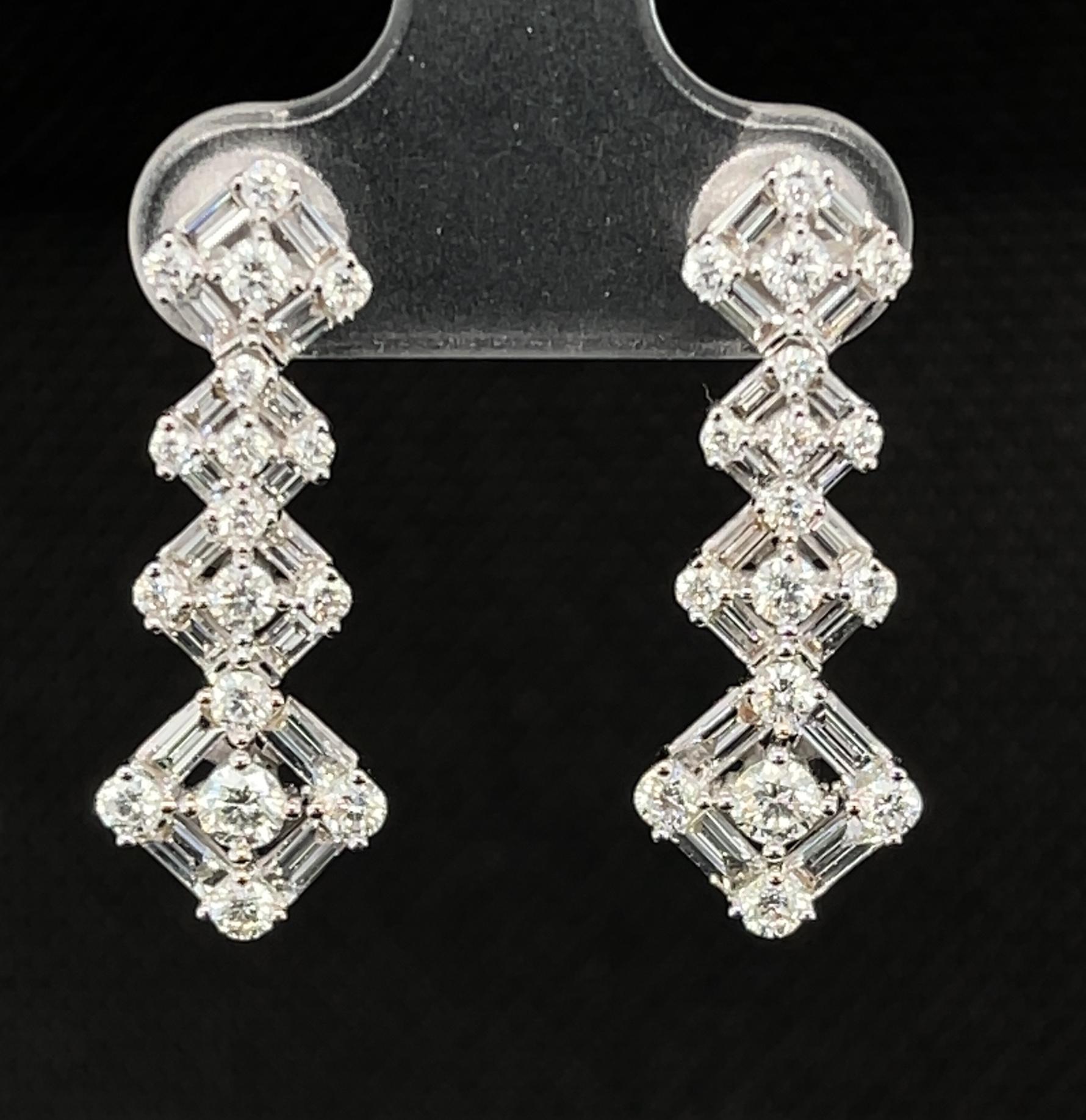 Baguette & round cut diamonds interweave to form these beautiful, dangling earrings. They are a fresh, geometric design that are as modern as they are classic. Sixty-six diamonds weighing a total of 1.83 carats are included in these stunning